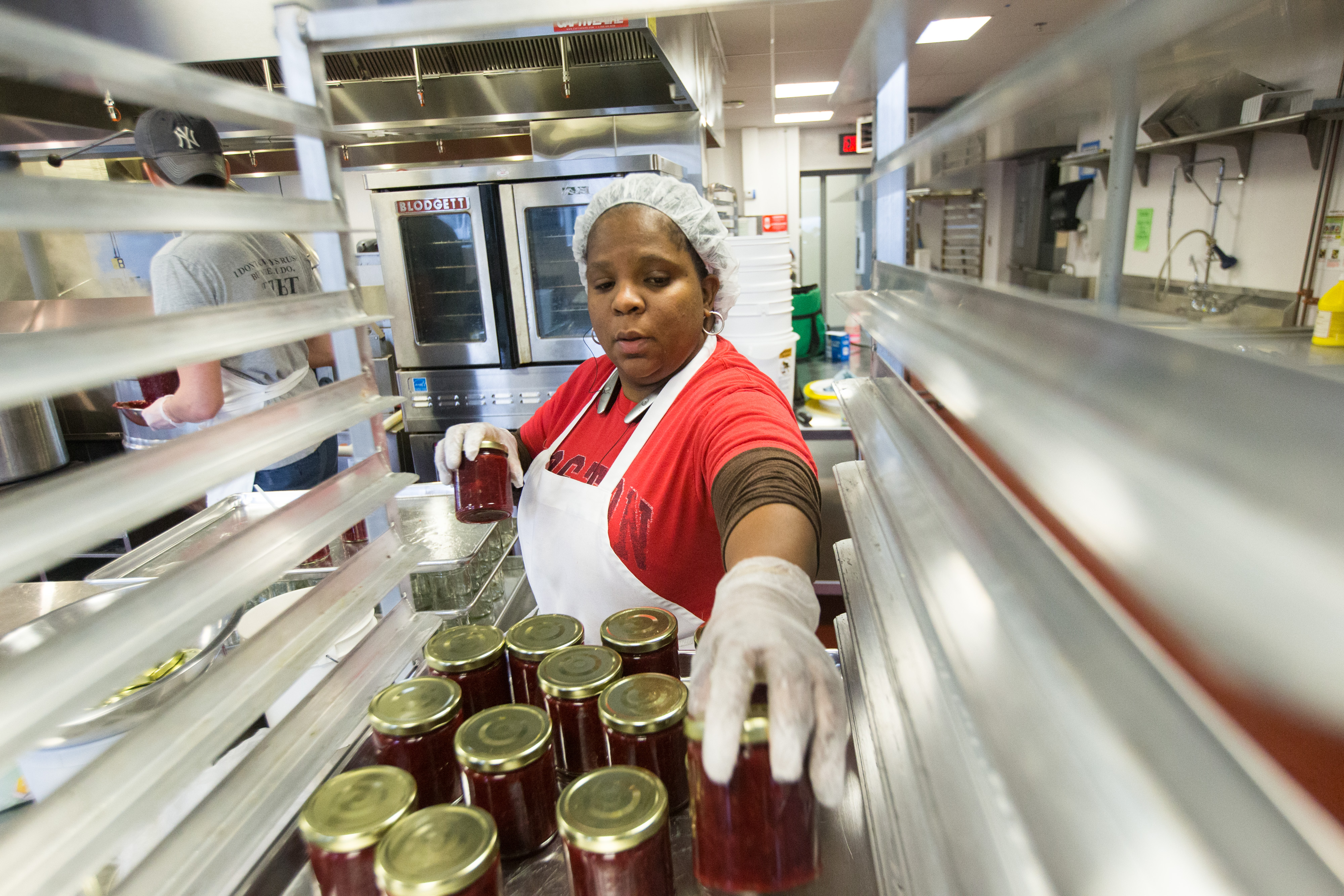 Kereen Pinnock of Deborah's Kitchen stacked jars of jam at the Commonwealth Kitchen in Boston.