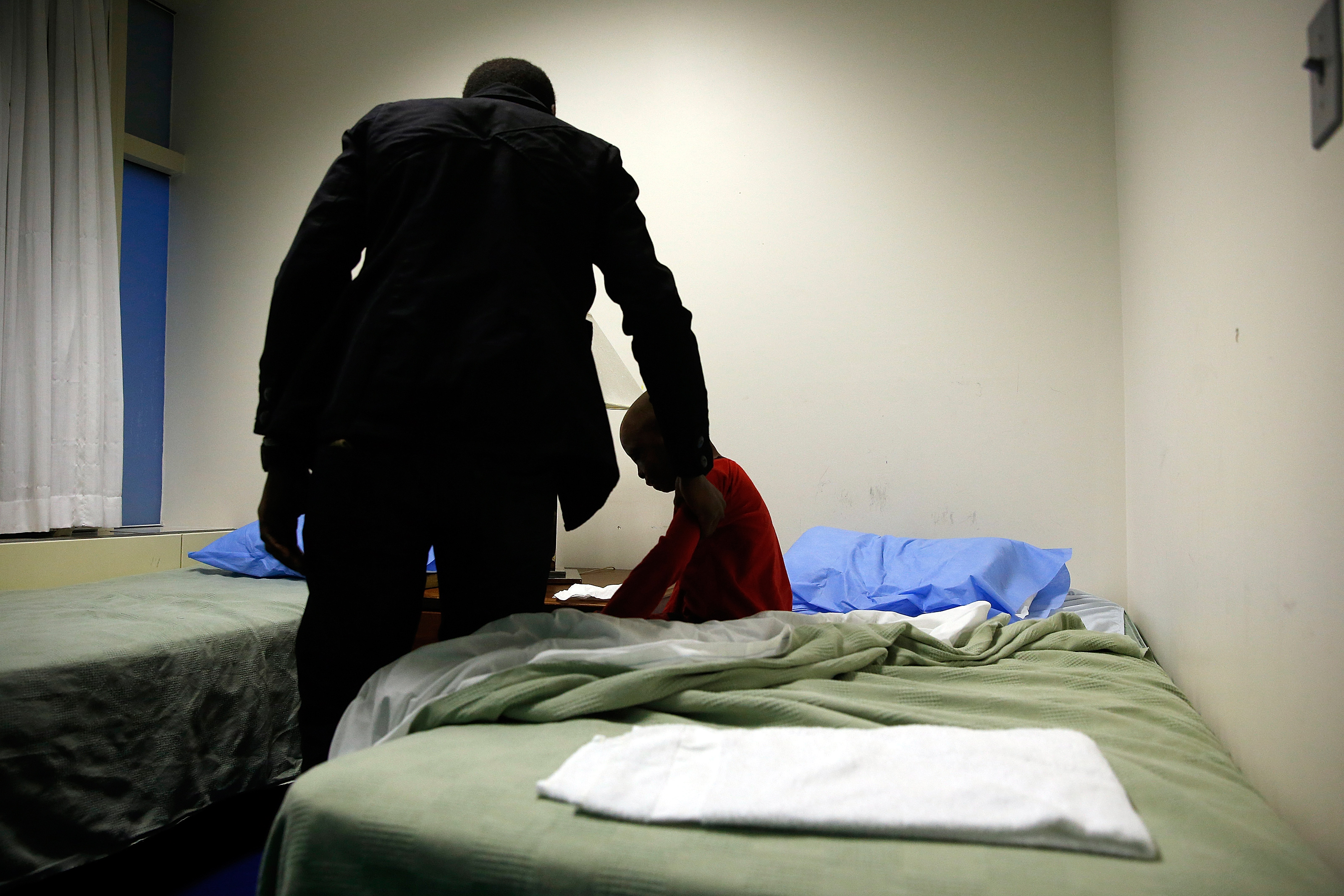 In a small room at Shriners Hospital, Alex woke Leo before his most recent surgery.