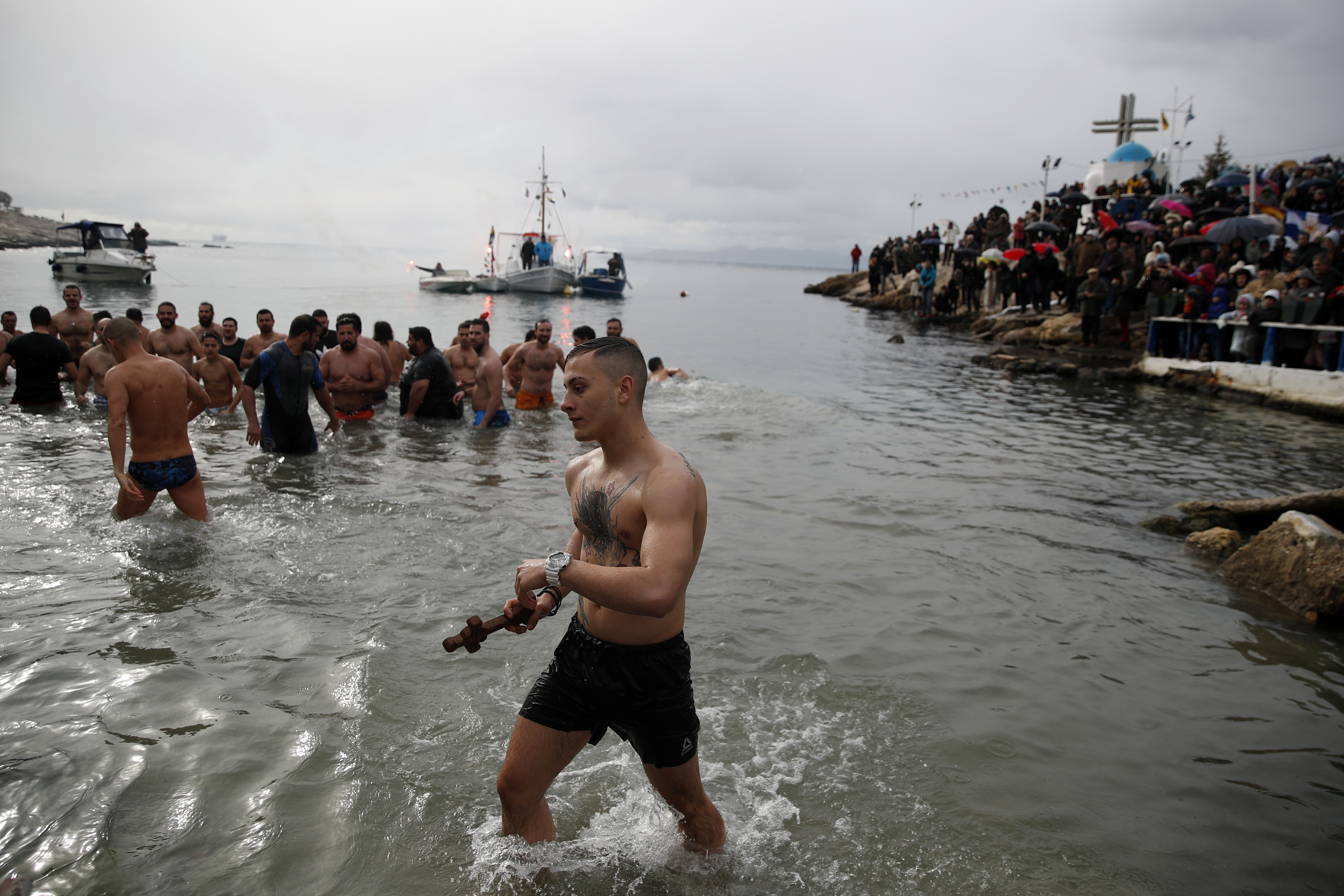 Ioannis Vlachakis held the cross after he retrieved it from the sea during a water blessing ceremony marking the Epiphany near Athens, Greece.
