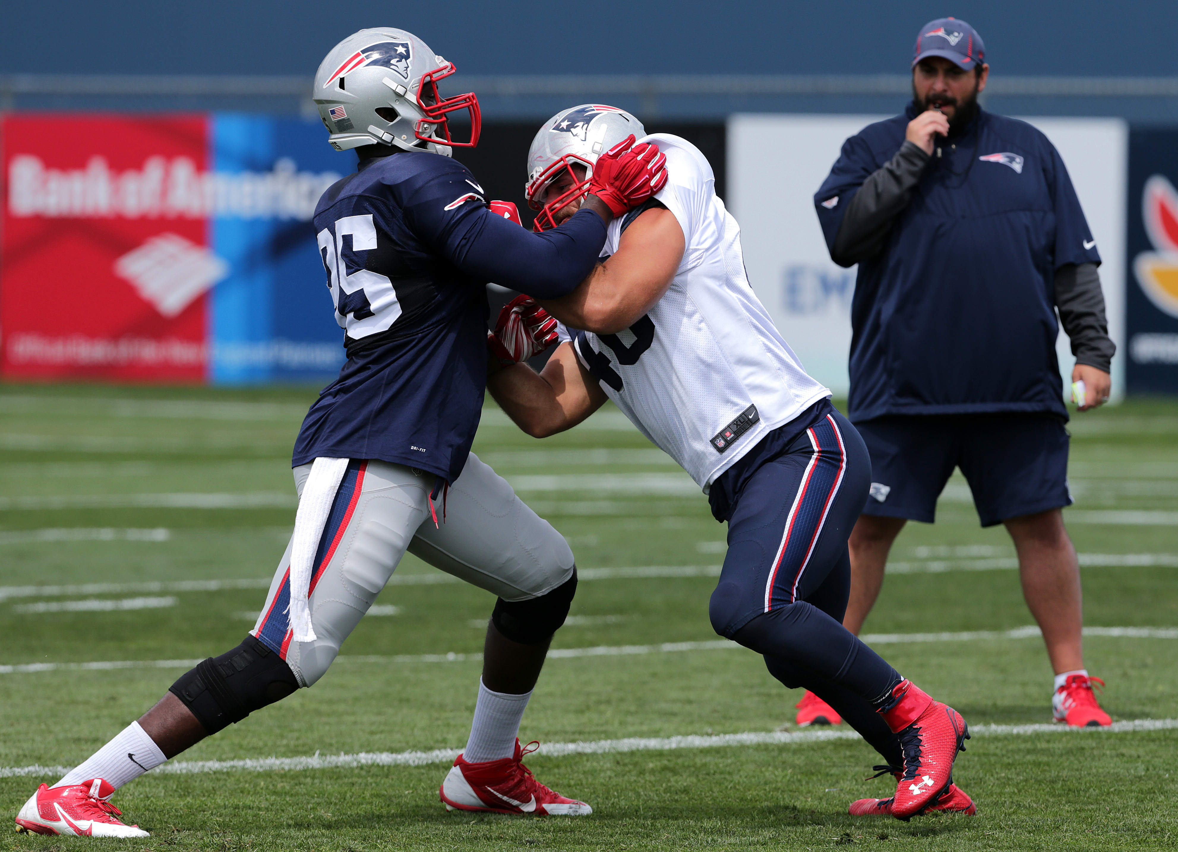 One-on-one drills — such as this battle between Chandler Jones (left) and James Develin during last year’s training camp — happen quickly, so be sure to take notes to evaluate later.