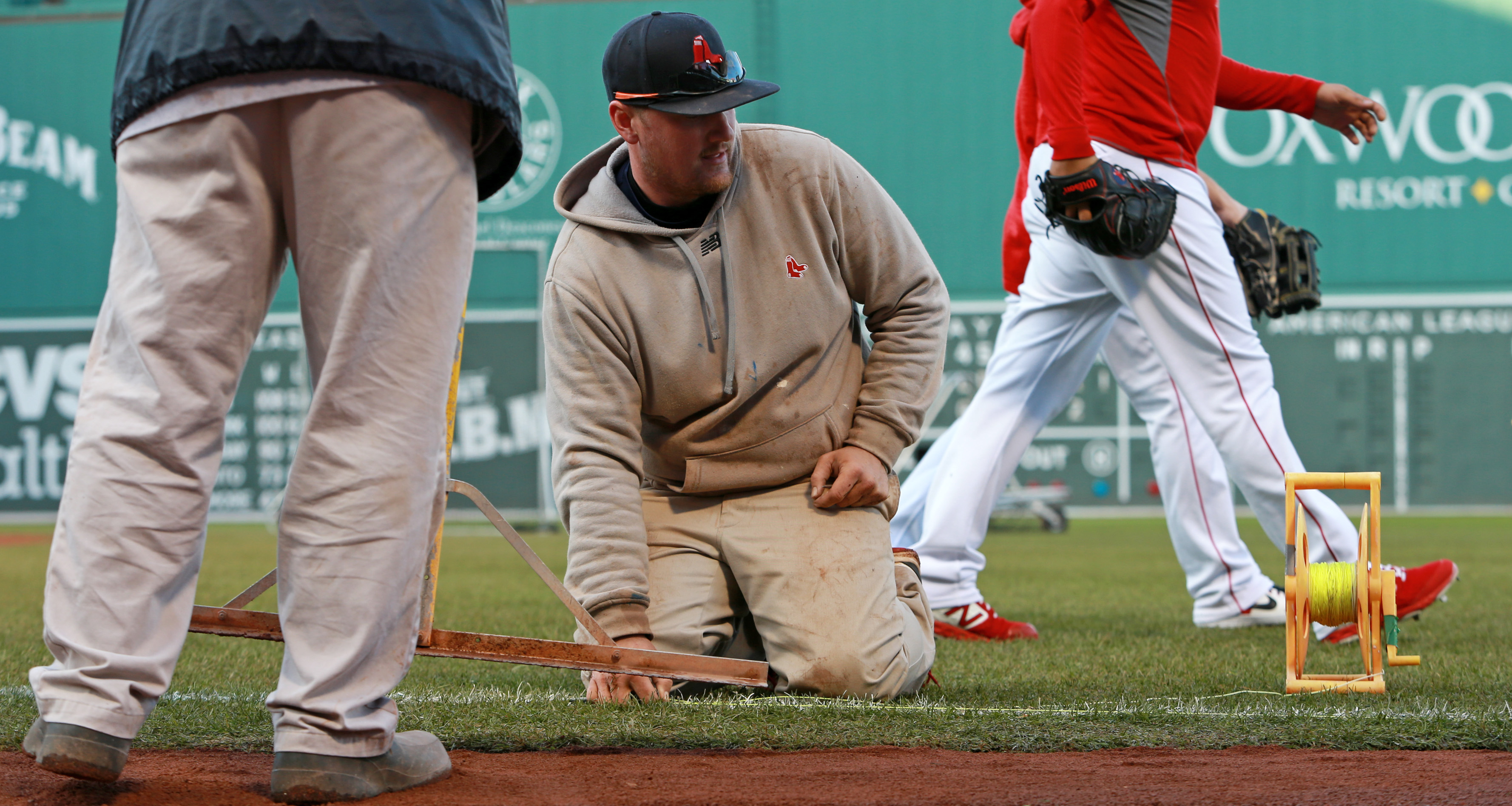 Members of the grounds crew were busy dropping a line in order to rechalk the right field foul line before Game 2.