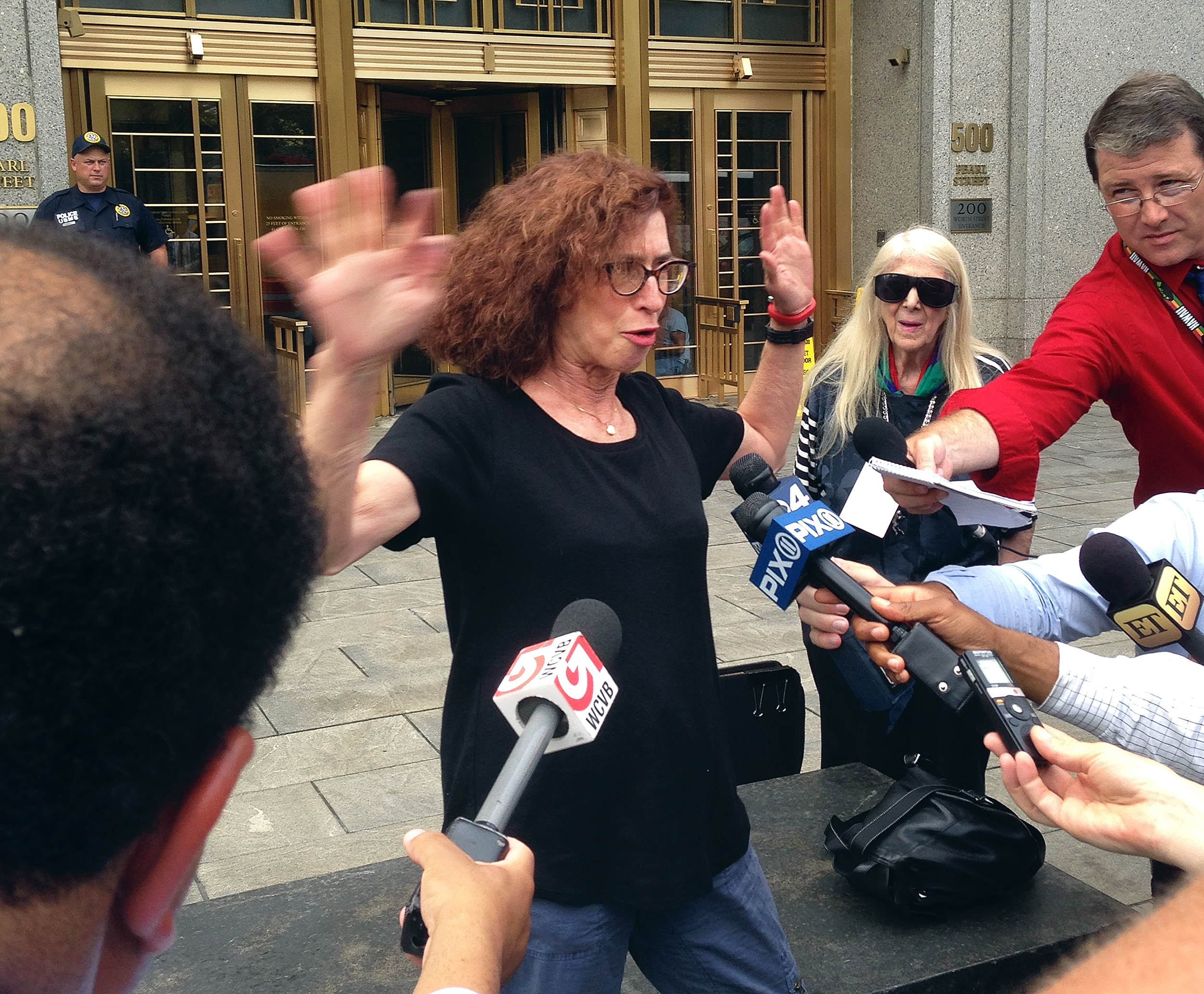 Courtroom sketch artist Jane Rosenberg was surrounded by the media outside of a federal courthouse in New York after one of the hearings.
