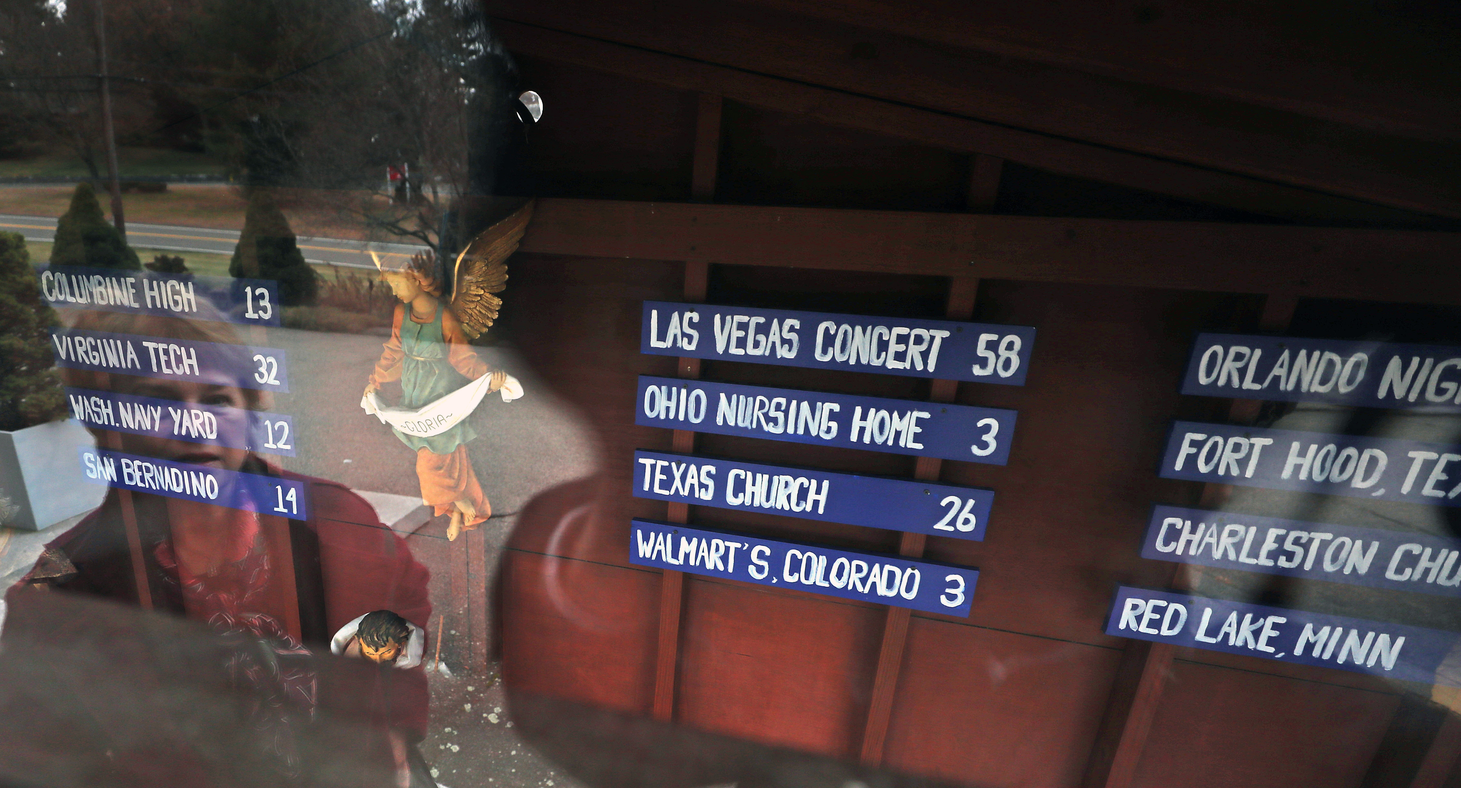 The Nativity scene outside the St. Susanna Church in Dedham shows list of locations where mass shootings have occurred and the number of victims.