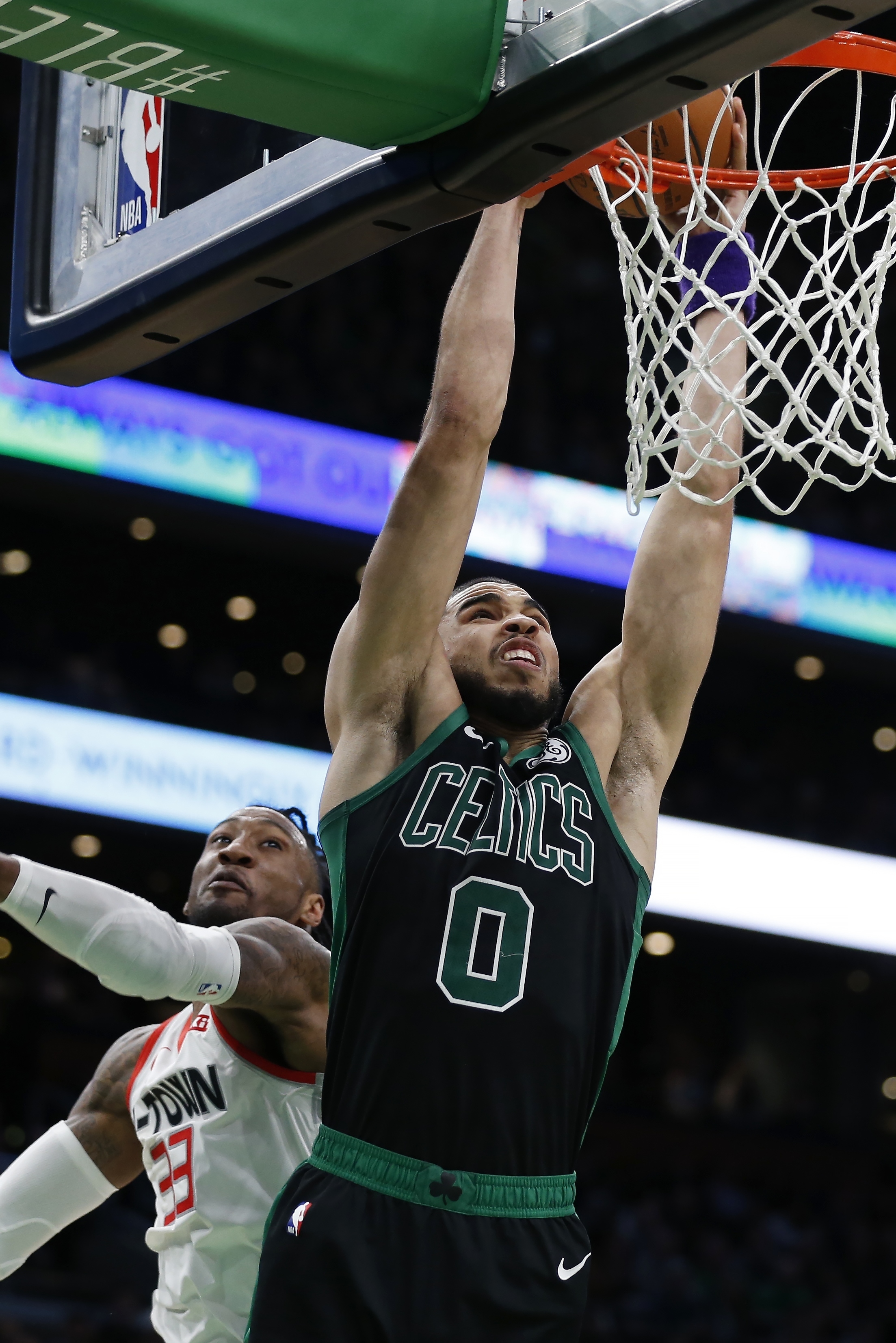 Jayson Tatum dunks past Robert Covington in the Celtics’ OT loss to the Rockets on Saturday night.