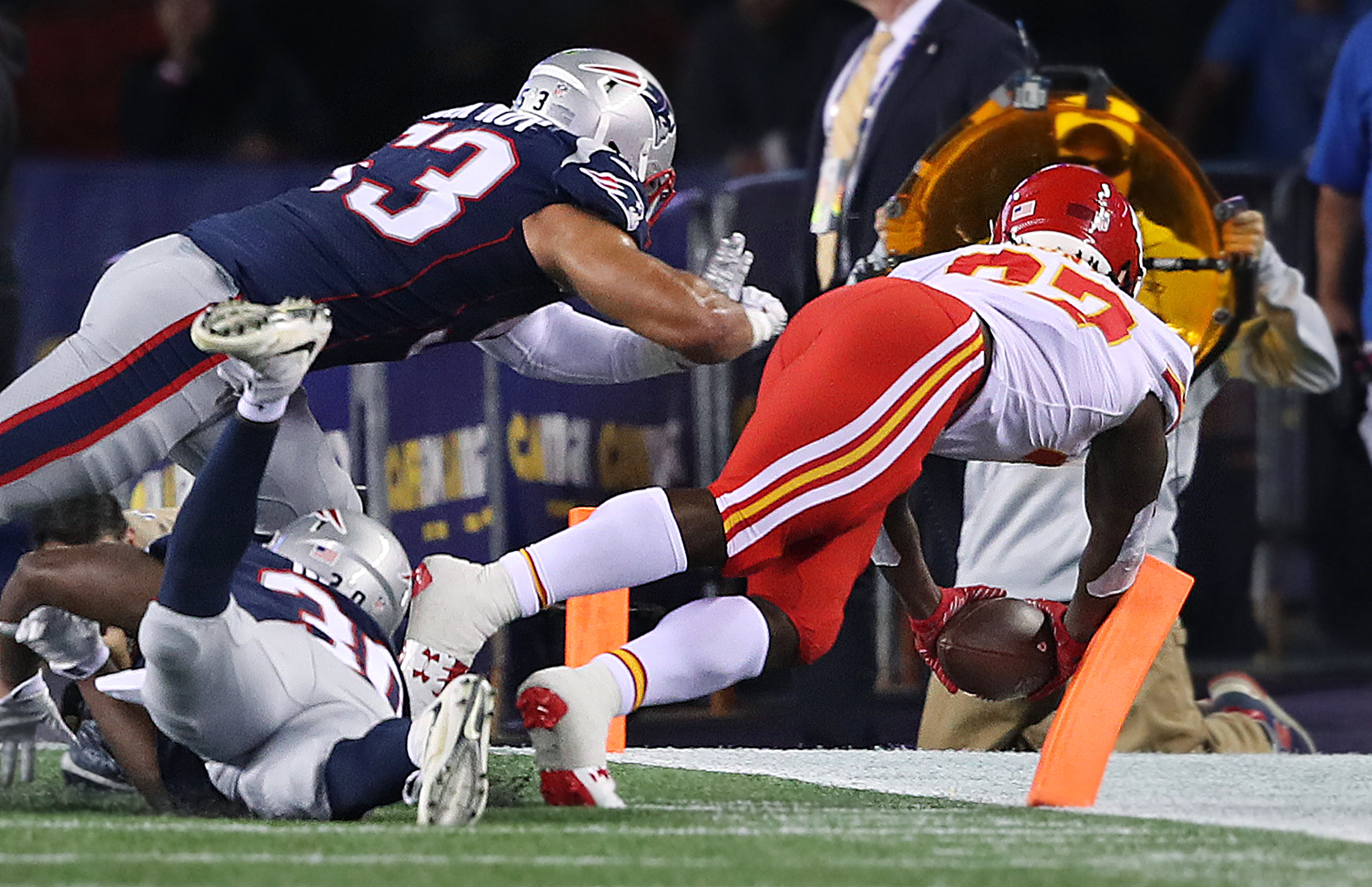 Kareem Hunt dives for a fourth quarter touchdown as the Patriots Kyle Van Noy (53) and Duron Harmon (30) are too late to stop him.