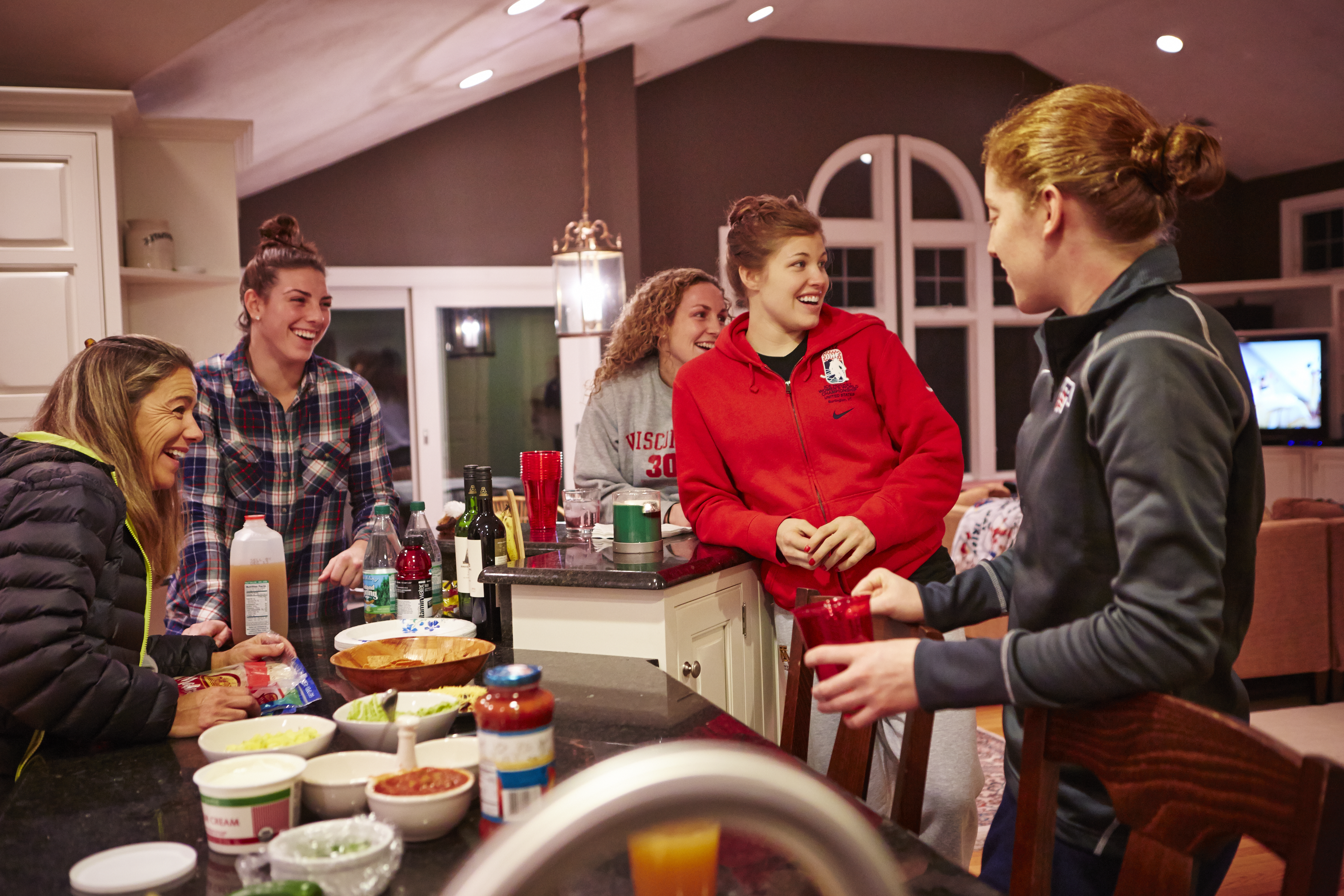At her Concord home, mom Kris Miller hosts burrito night for players Hilary Knight, Jessie Vetter, Anne Schleper, and Molly Schaus.