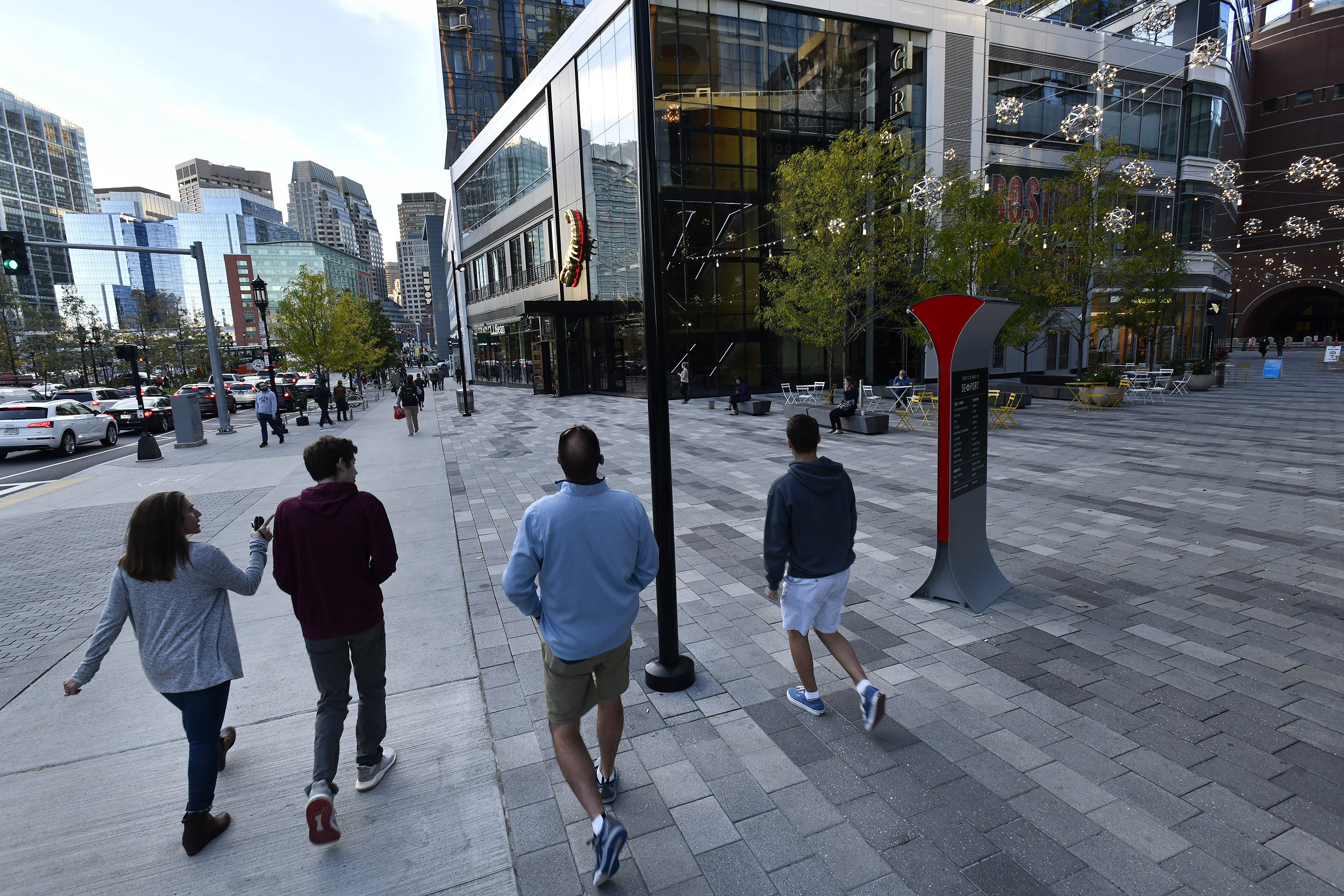 Pedestrians crossed the plaza outside the One Seaport complex, which has many restaurants, bars, a bowling alley, and movie theater.