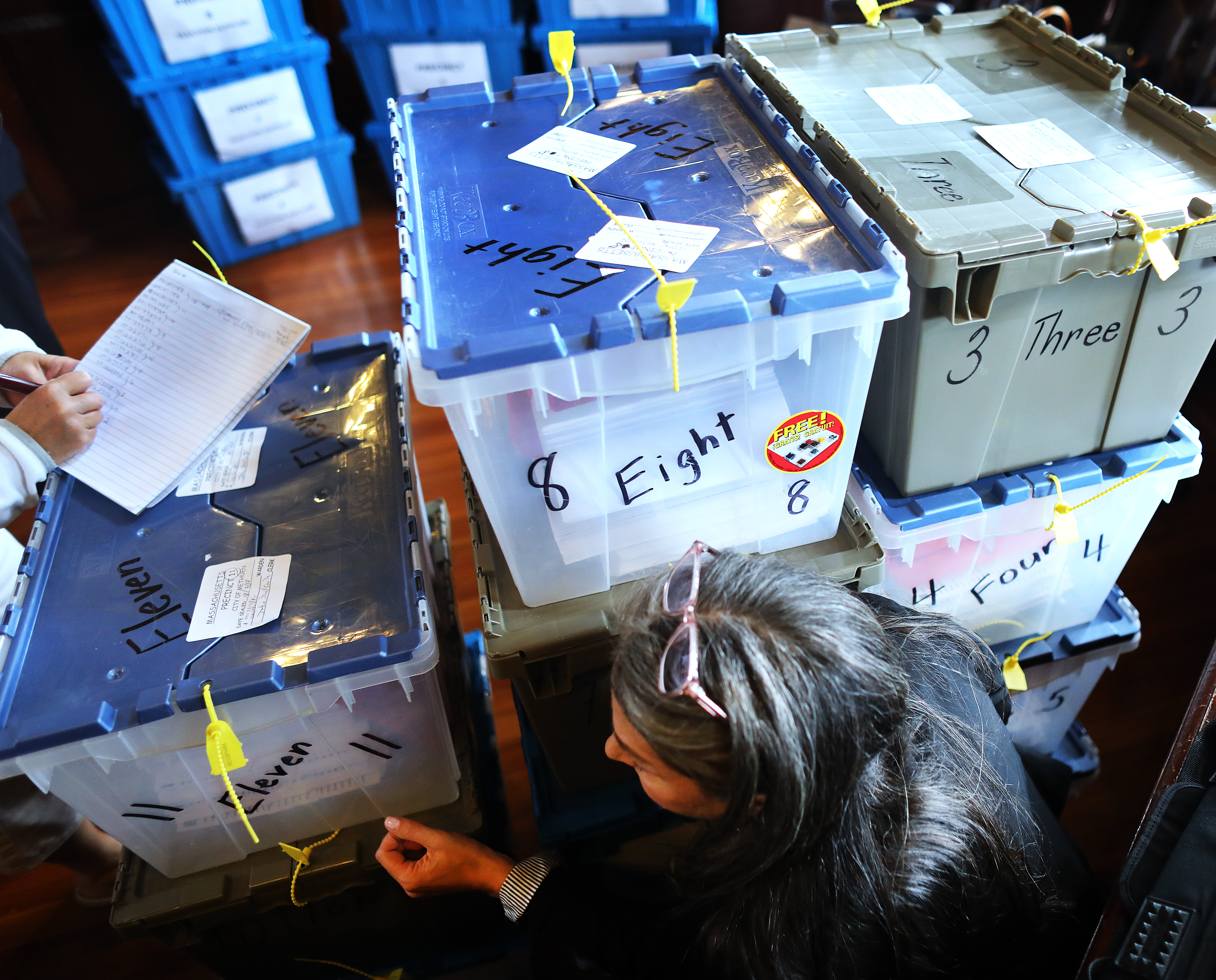 Hired by the city, attorney Lauren F. Goldberg read tag numbers from the ballot precinct boxes to community development secretary Nancy Hudson.