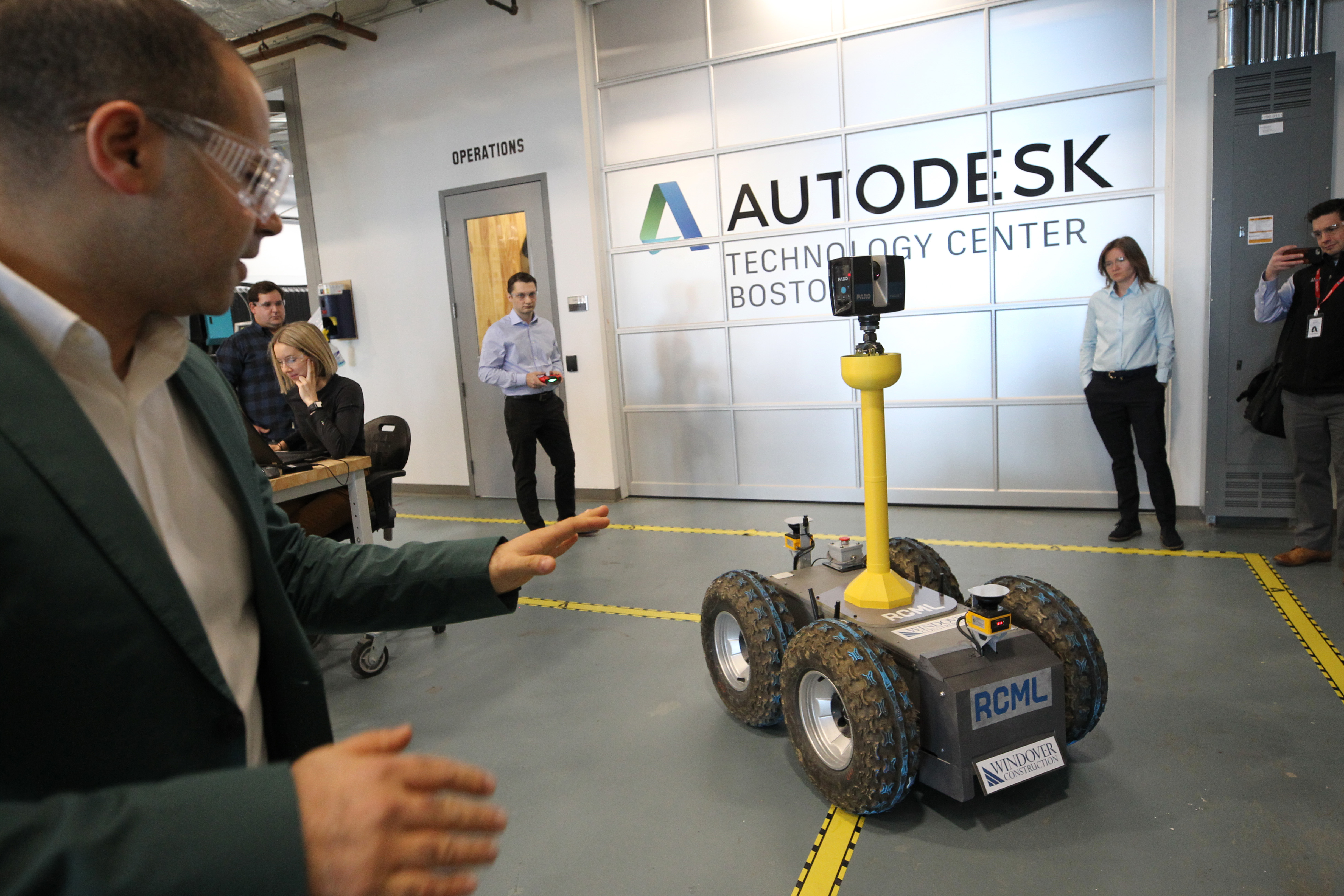Amr Raafat, a vice president at Windover Construction, demonstrates the Oliver robot by Boston startup RCML that takes highly detailed scans of building sites.