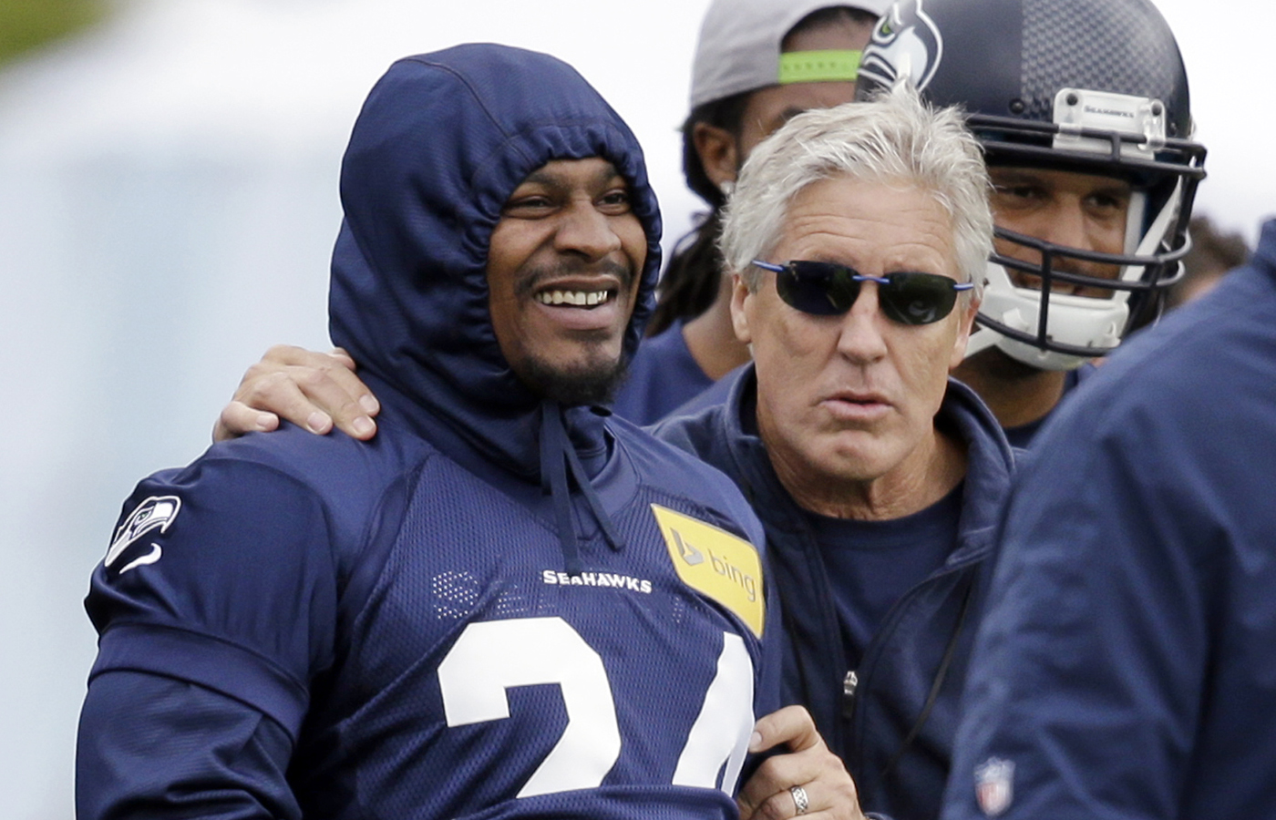 Marshawn Lynch reported to minicamp for Seahawks head coach Pete Carroll, right, in June. Will he be there when training camp opens?