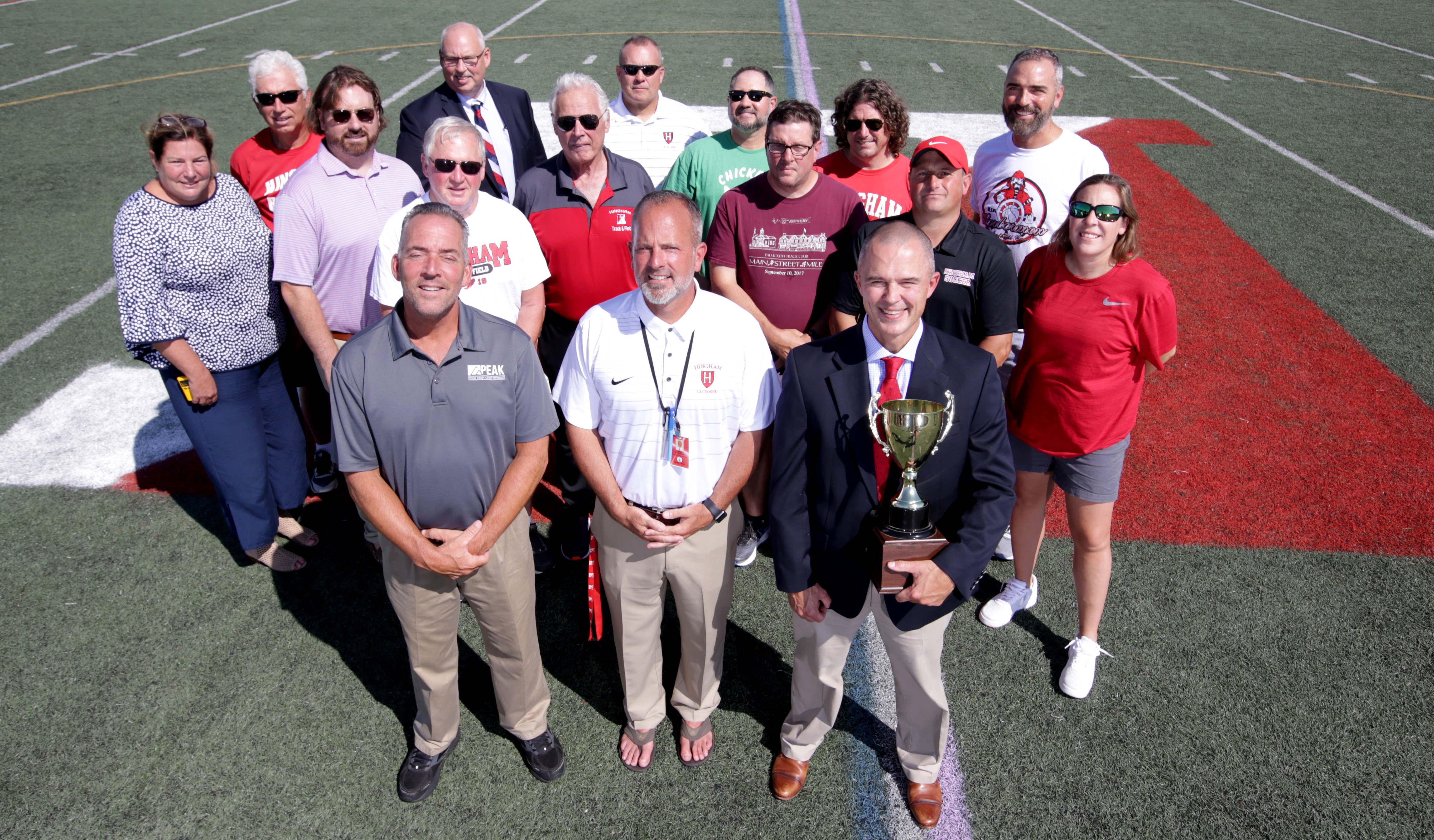 Athletic director Jim Quatromoni (center) along with administrators and coaches from Hingham High overesee a program in which 79 percent of the school’s 1,270 students participate in athletics.