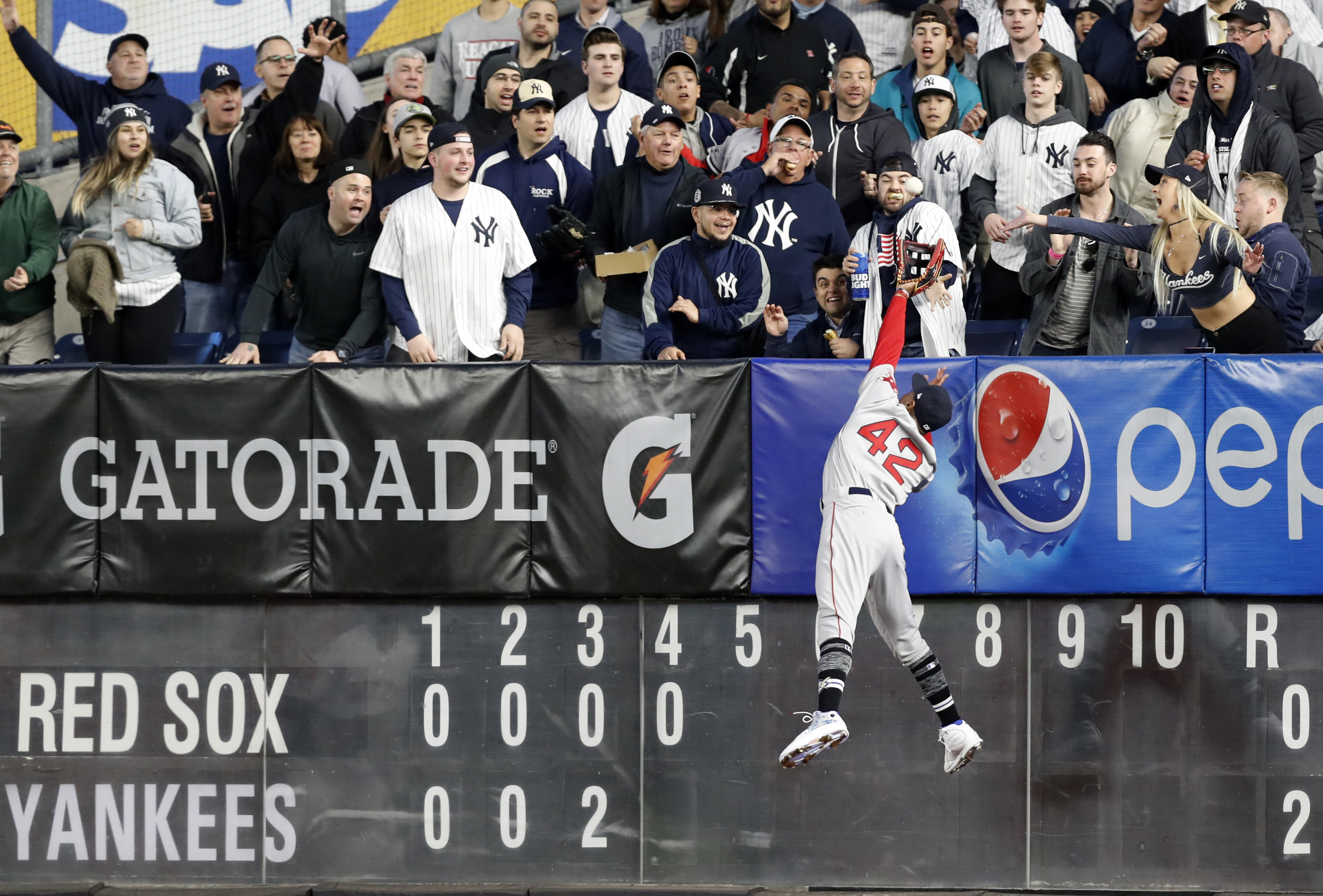 Red Sox right fielder Mookie Betts can't get to a solo home run by Clint Frazier during the fourth inning Tuesday.