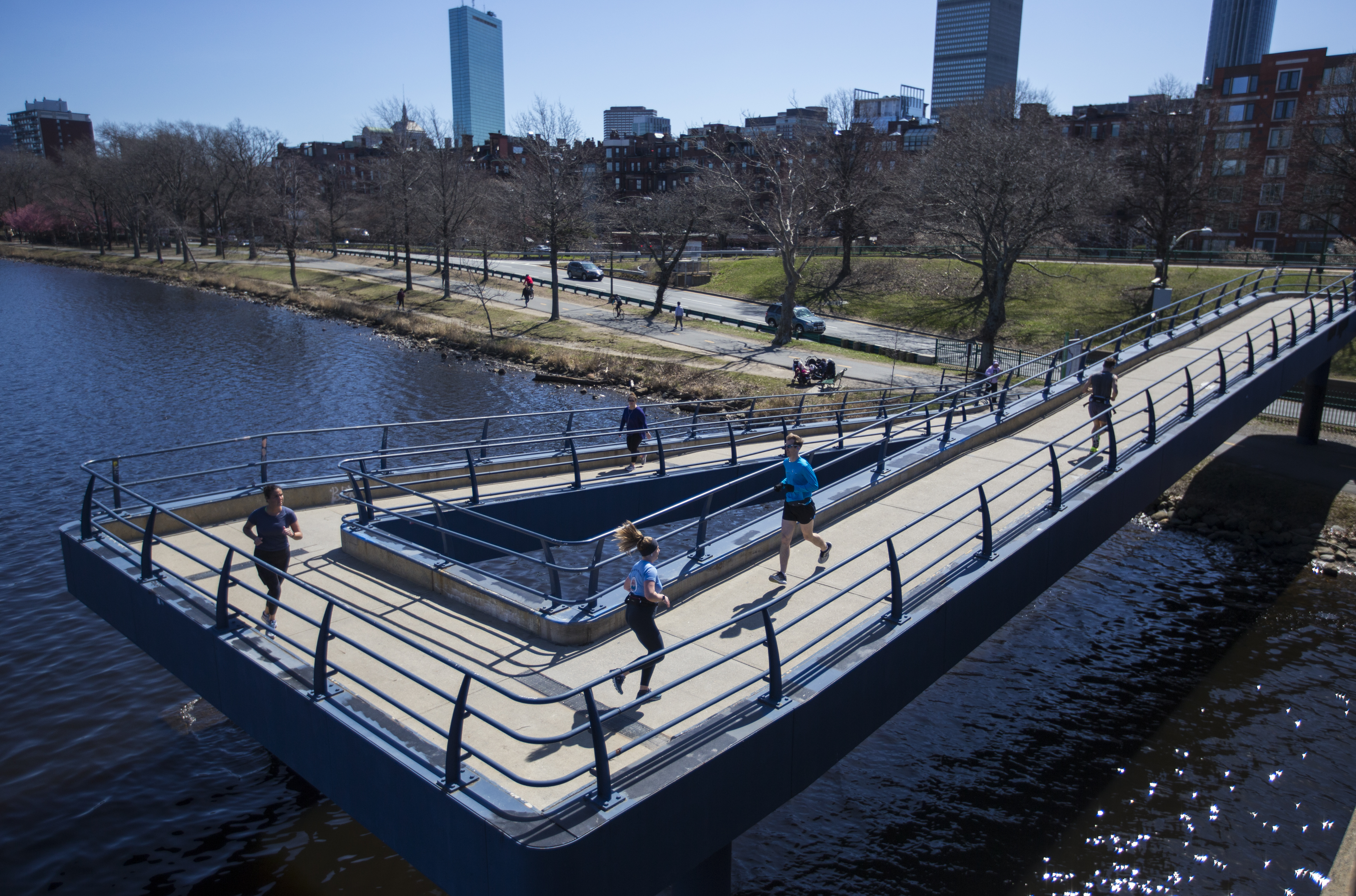 Five runners made their way on the footbridge connecting Massachusetts Avenue and the Esplanade on Monday.