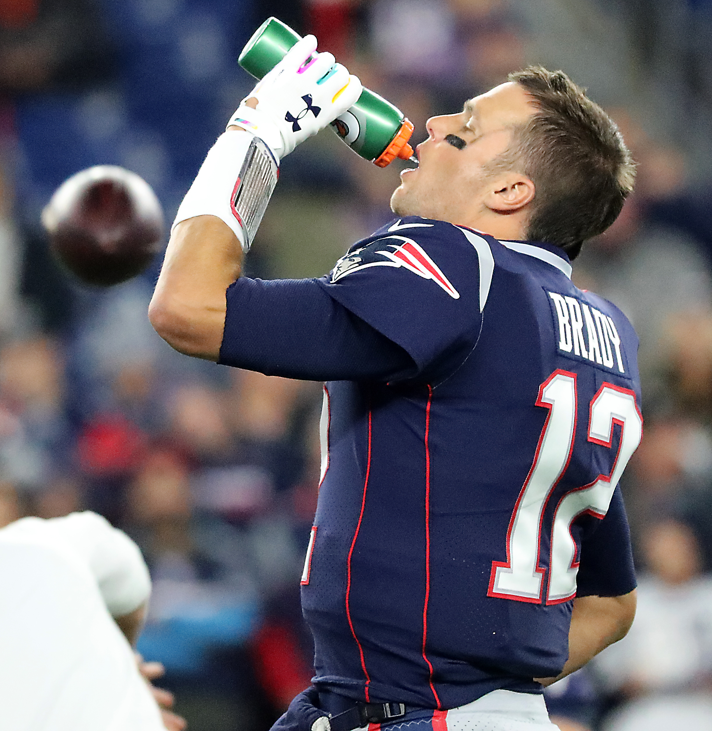 Tom Brady getting a drink during warmups.