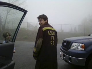 Justin Fournier, wearing his mother’s gear, was to start firefighter training next month.