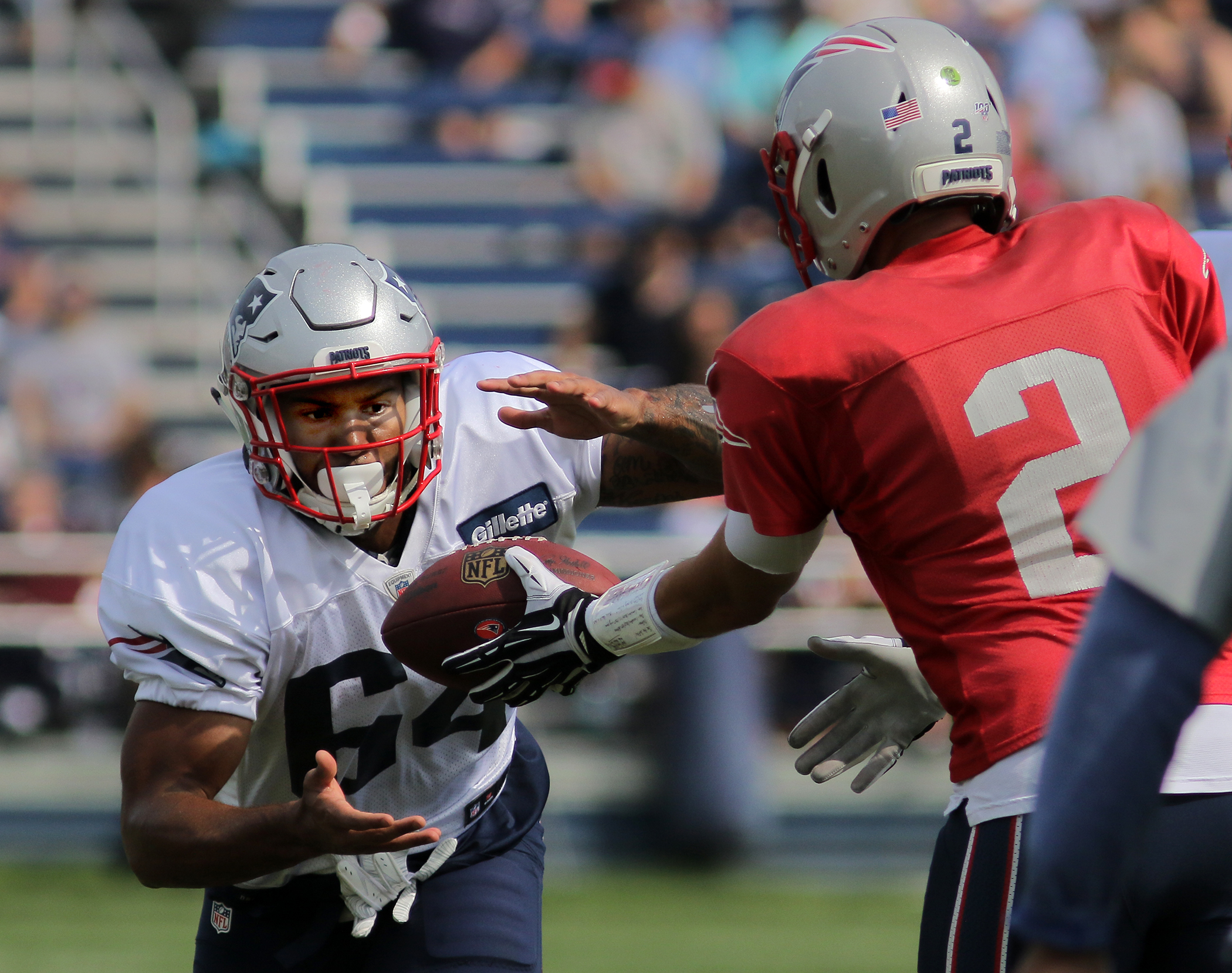 Nick Brossette takes a handoff from Brian Hoyer during a 2019 training camp practice.