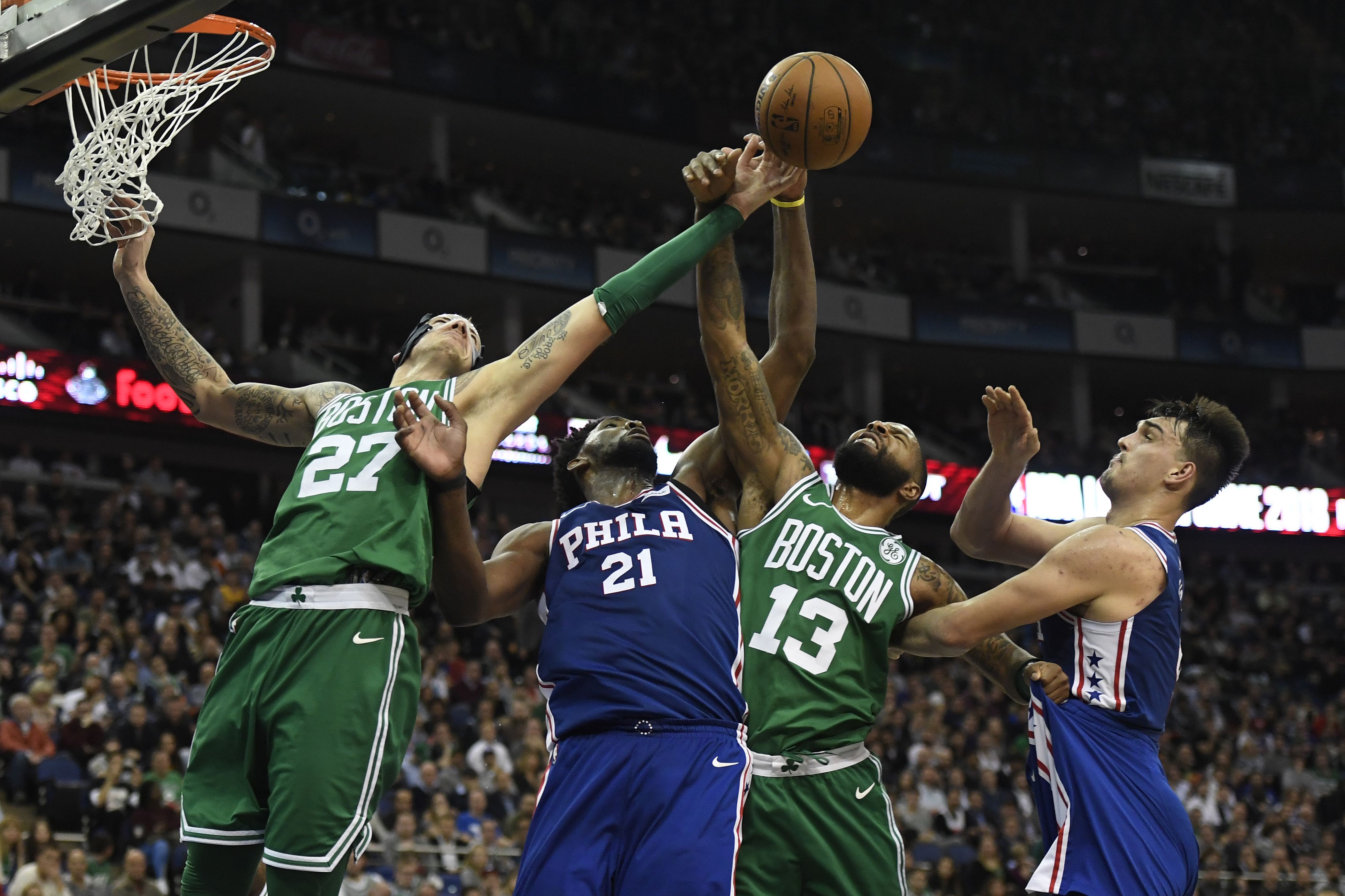 Daniel Theis (left) and Marcus Morris fight for the ball against Joel Embiid (No. 21) and Dario Saric.