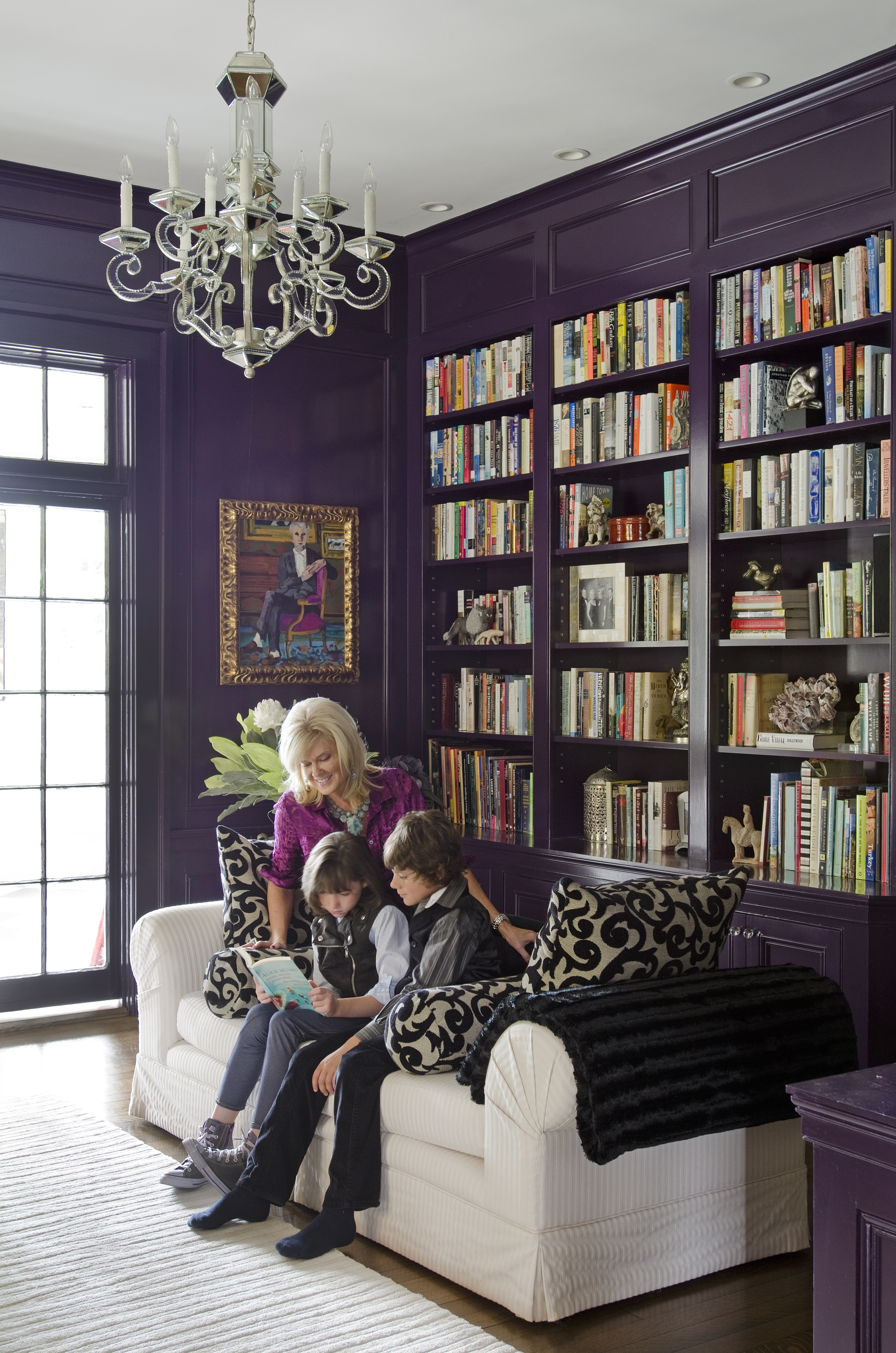 Katrina Maestri, shown with her two children, loved the idea of a glossy purple library.
