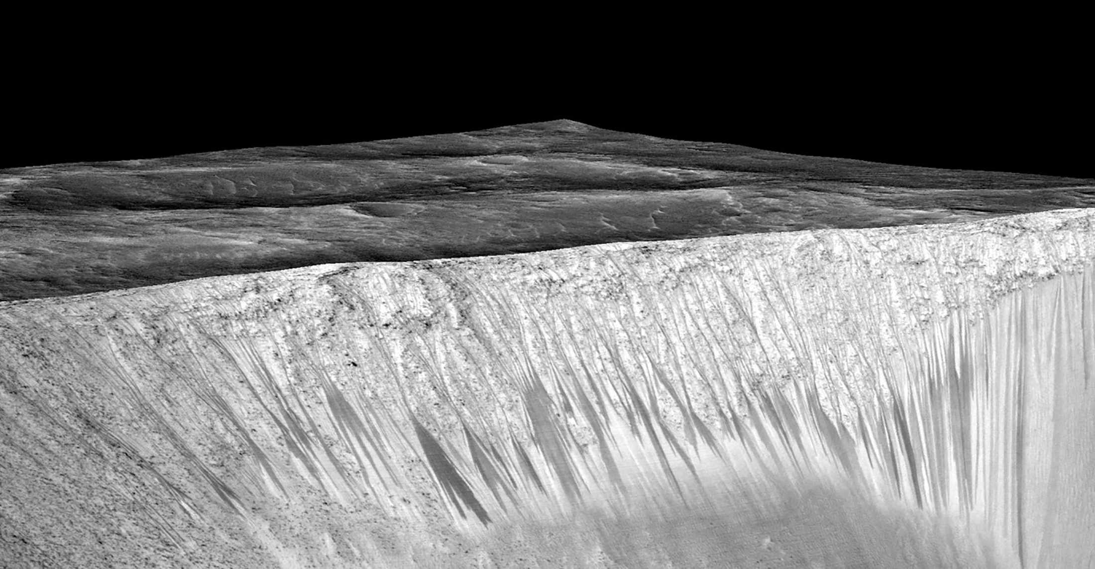 Dark narrow streaks called recurring slope lineae emanating out of the walls of Garni crater on Mars were seen in an image produced by NASA, Jet Propulsion Laboratory (JPL) and the University of Arizona.