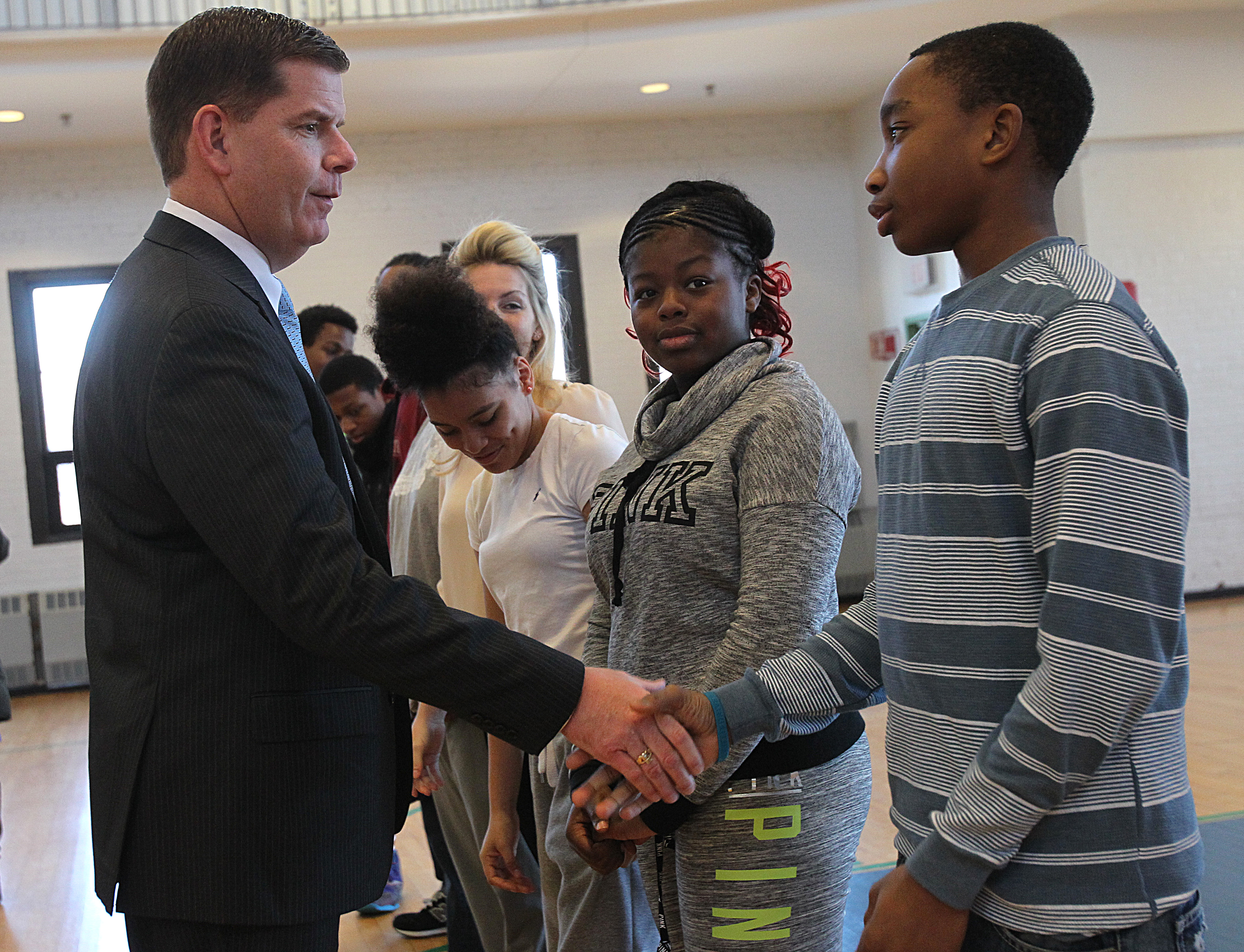 Mayor Walsh greeted Boston middle-school student Vanell Dominique before the press conference on Friday.