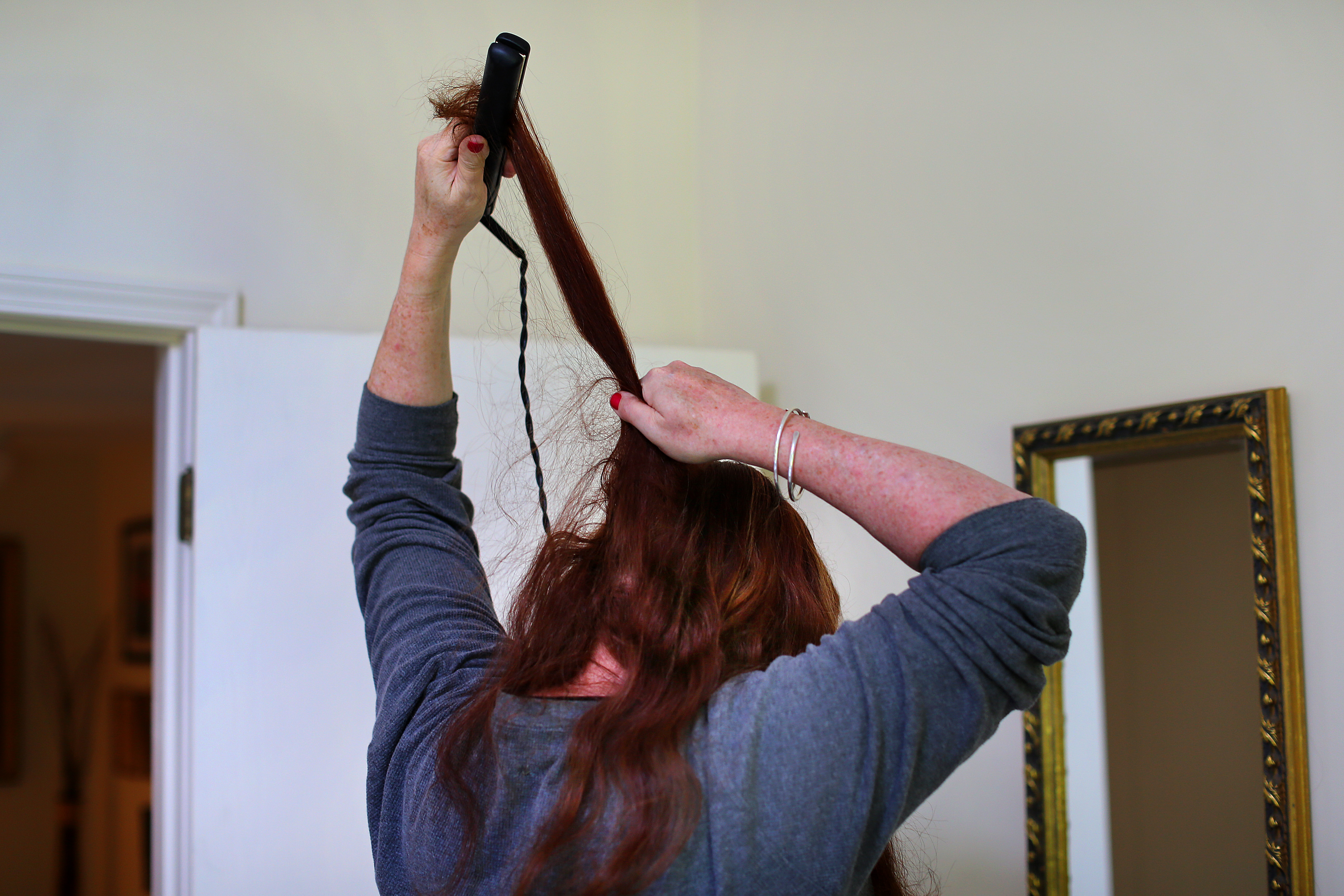Lindsey Straus straightened her hair in her bedroom at home as she got ready for the Sunday morning church.