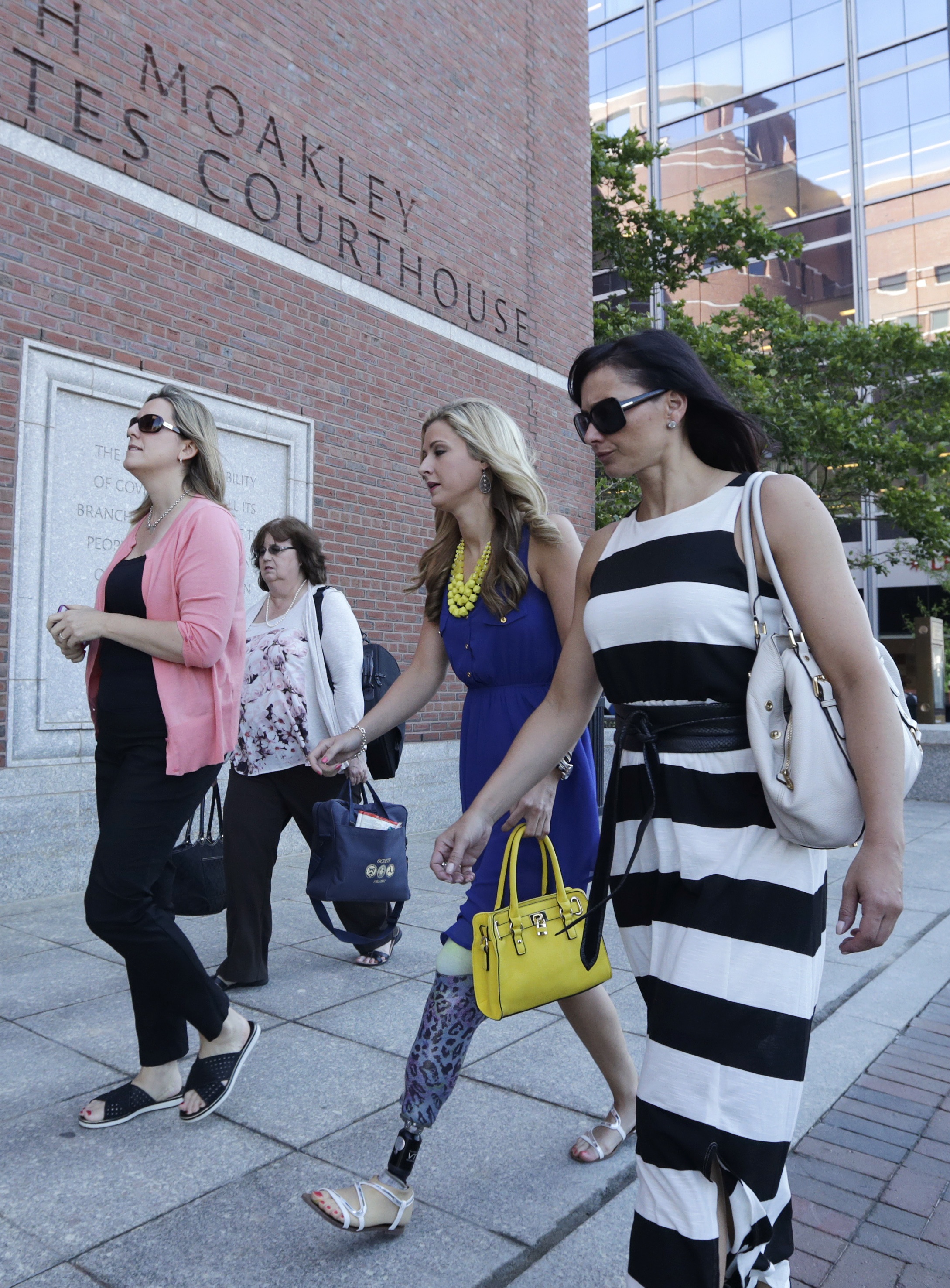 Bombing survivor Rebekah Gregory, second from right, walked toward the courthouse.