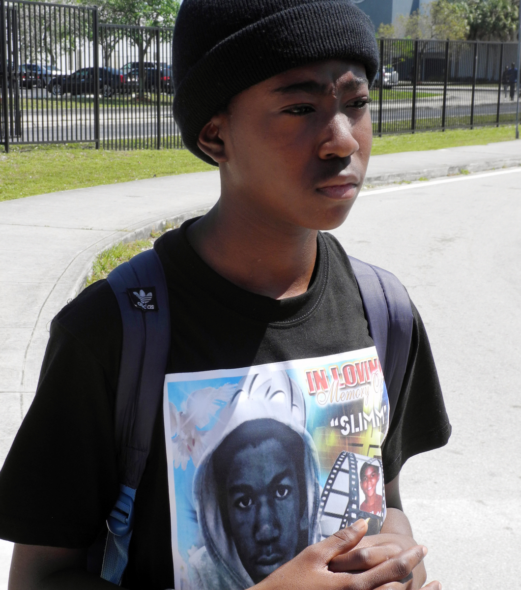 A former classmate of Trayvon Martin, 16-year-old Joel Escarment, wears a shirt honoring Martin at his Miami high school.