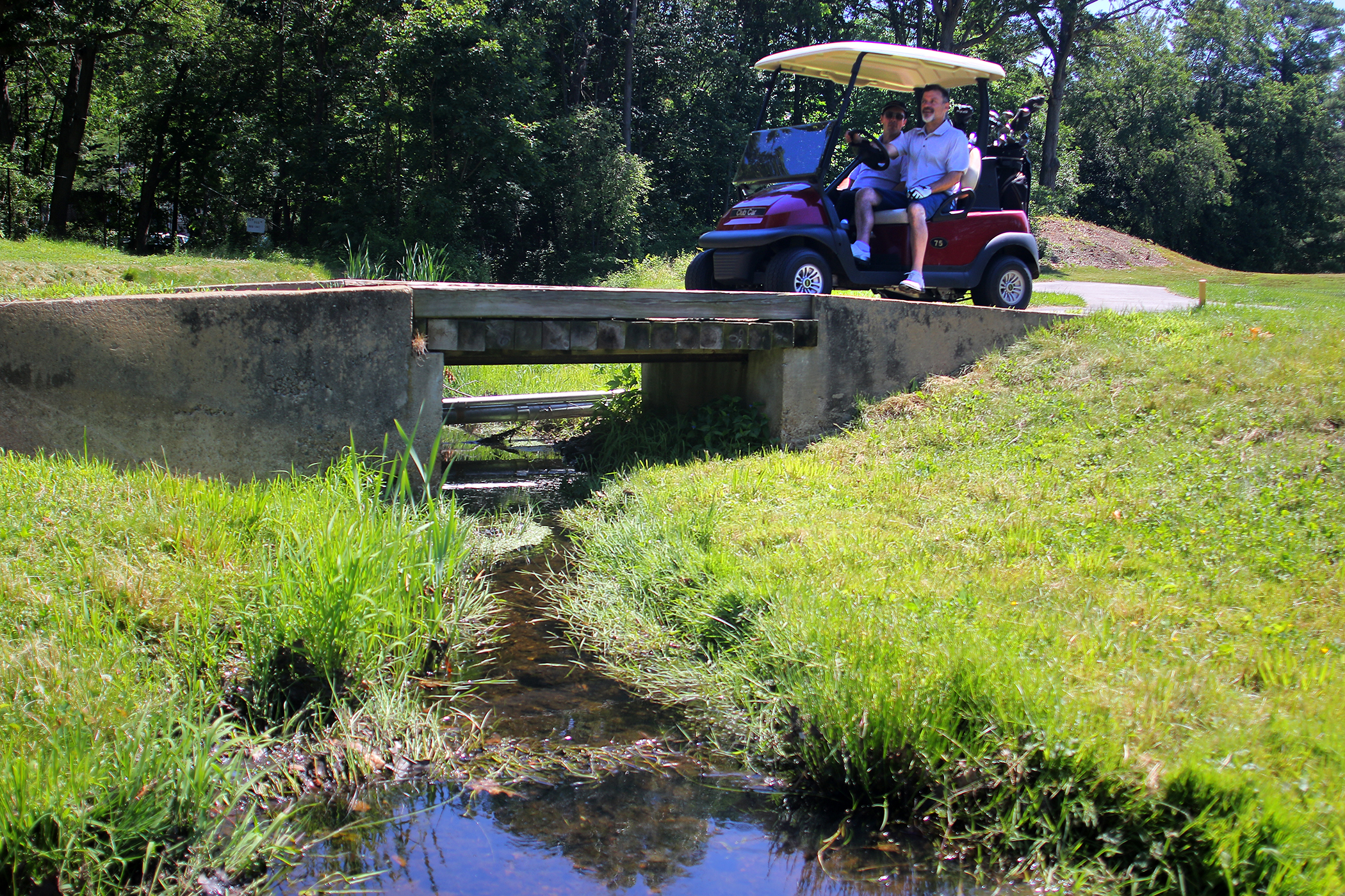 Golfers crossed a small creek on 18th hole at George Wright Golf Course.
