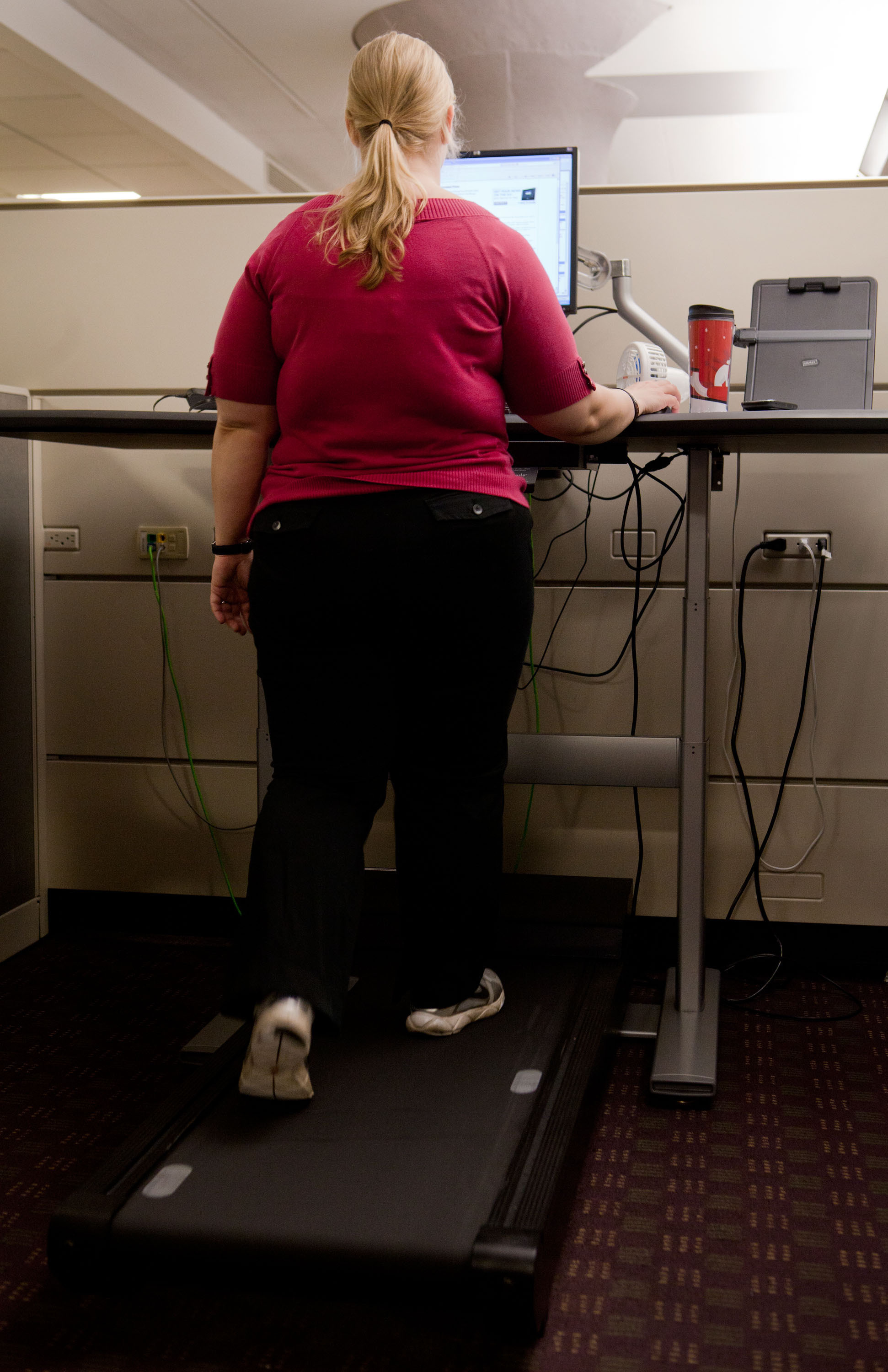Elyse Blanda, a contract specialist at the Blue Cross Boston office, has decided to use a treadmill desk at work.