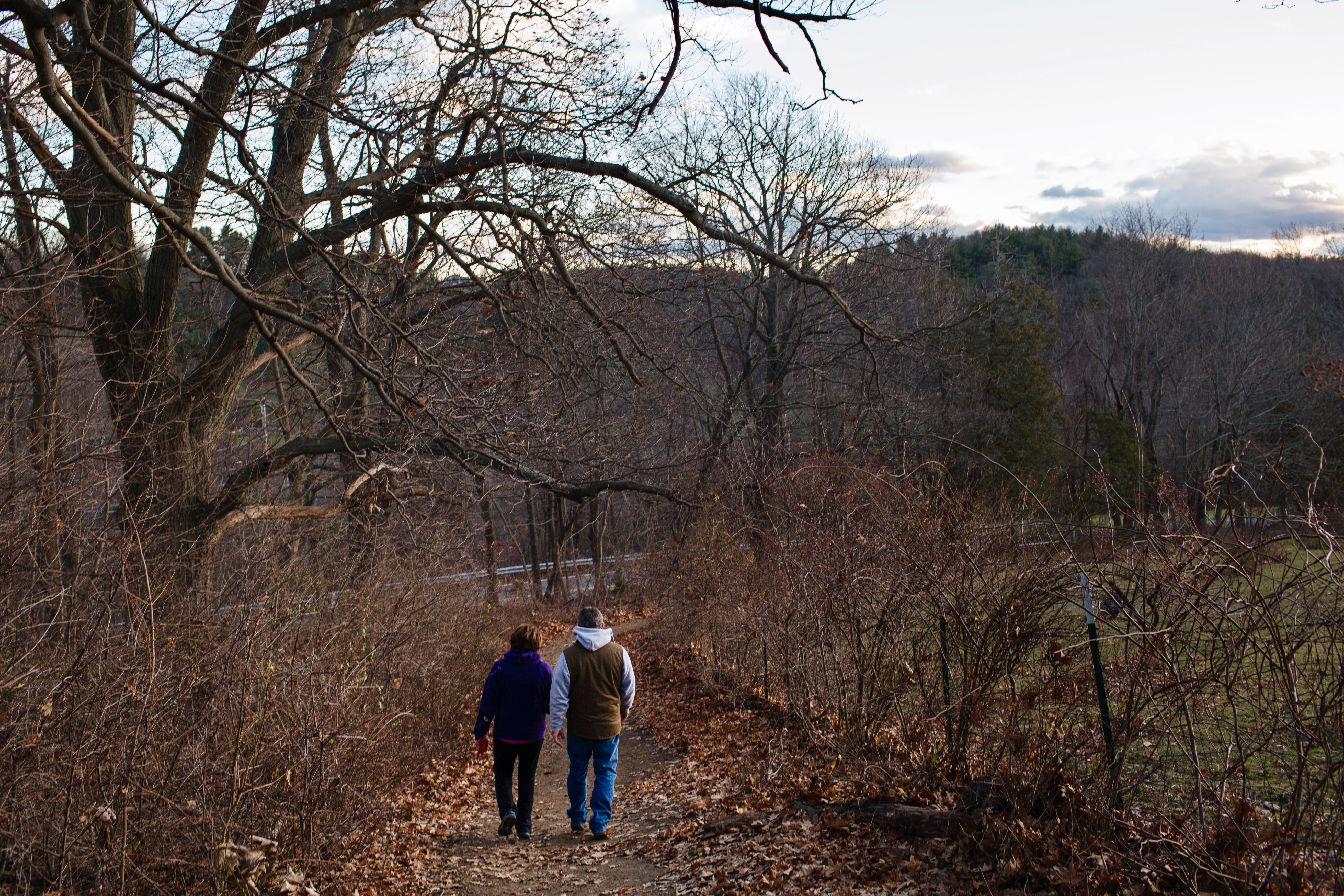 A couple walks on the path to Bancroft Castle.