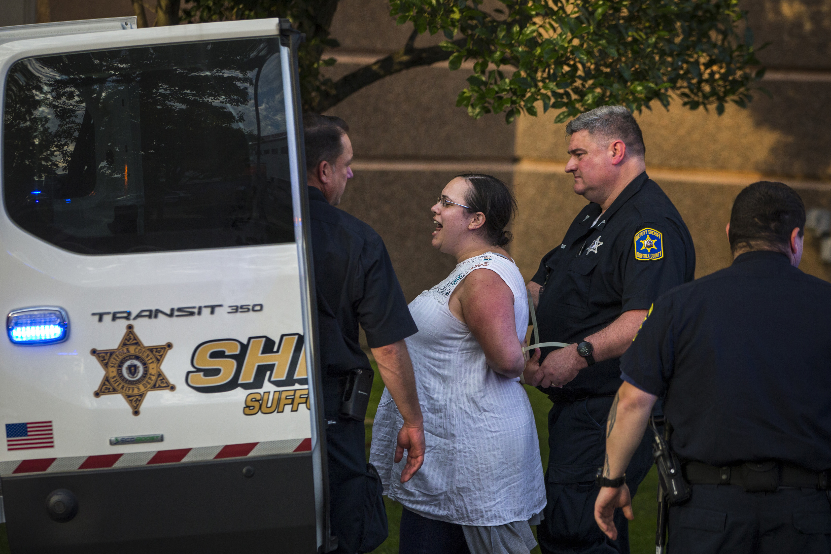A protester was arrested during the march and rally outside of the Suffolk County Sheriff's Department in Boston on Tuesday.