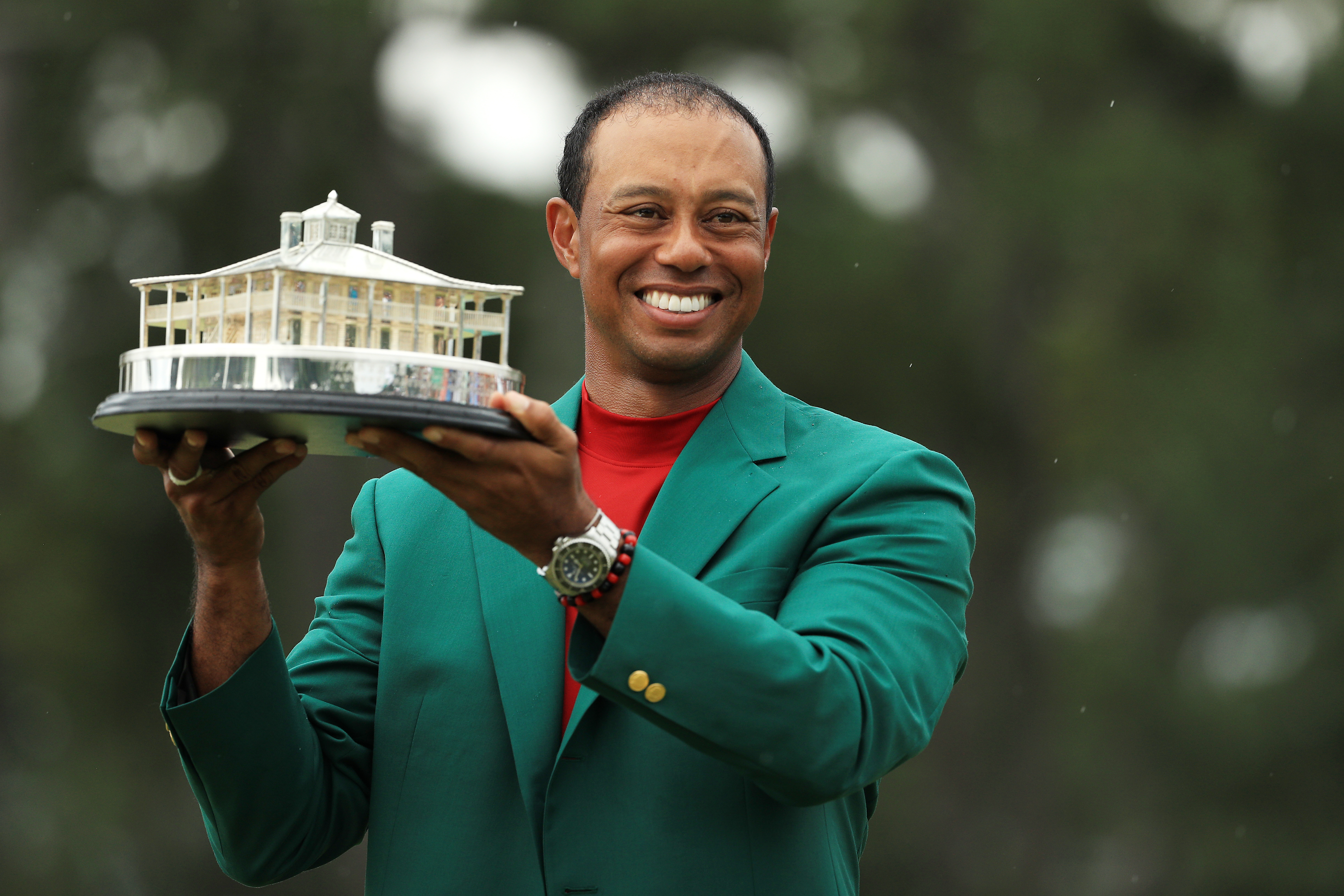 Tiger Woods displays the Masters Trophy following his victory Sunday.