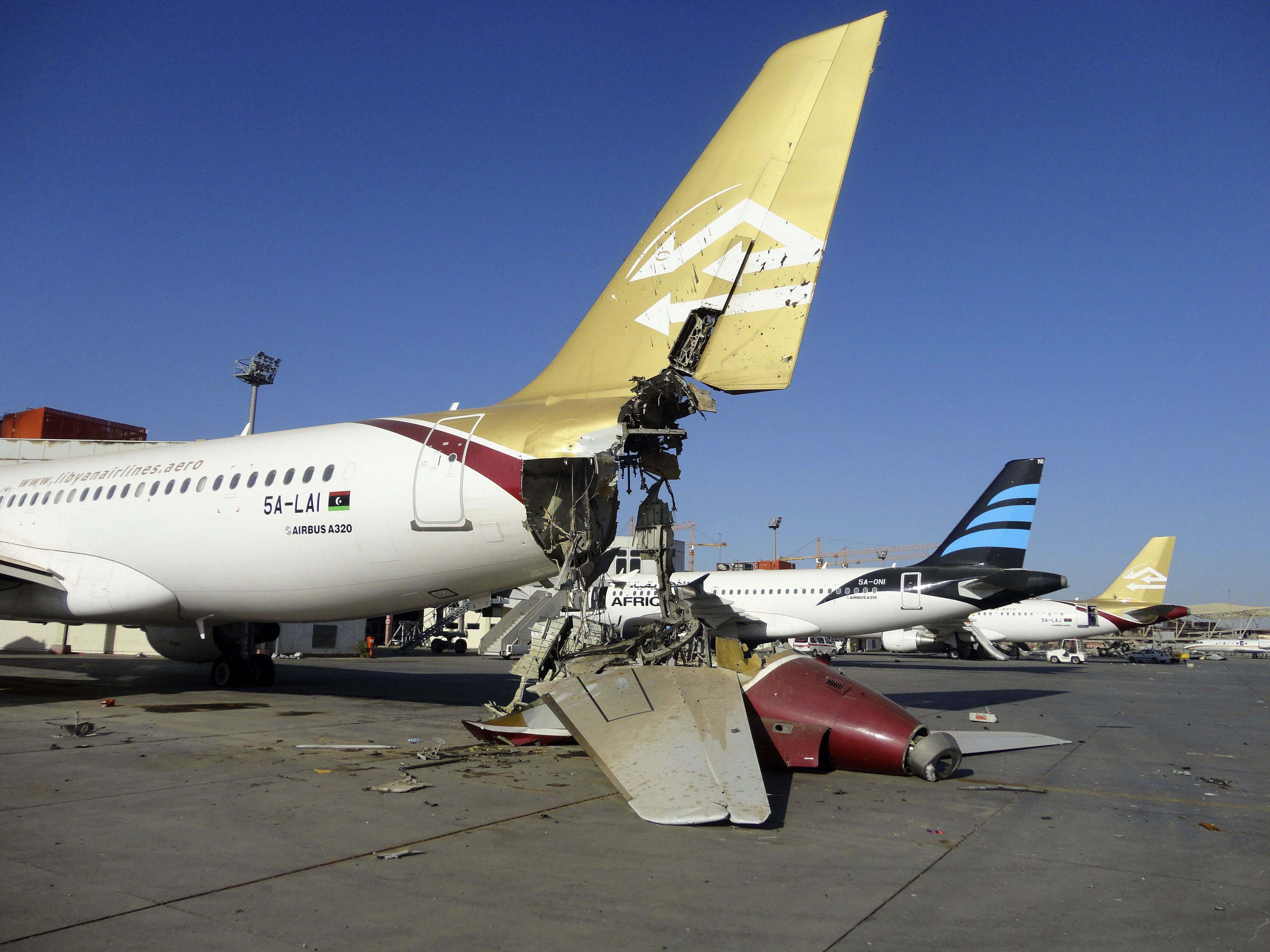 Damaged aircraft is seen at Tripoli International Airport after unidentified war planes attacked targets in the Libyan capital in August.