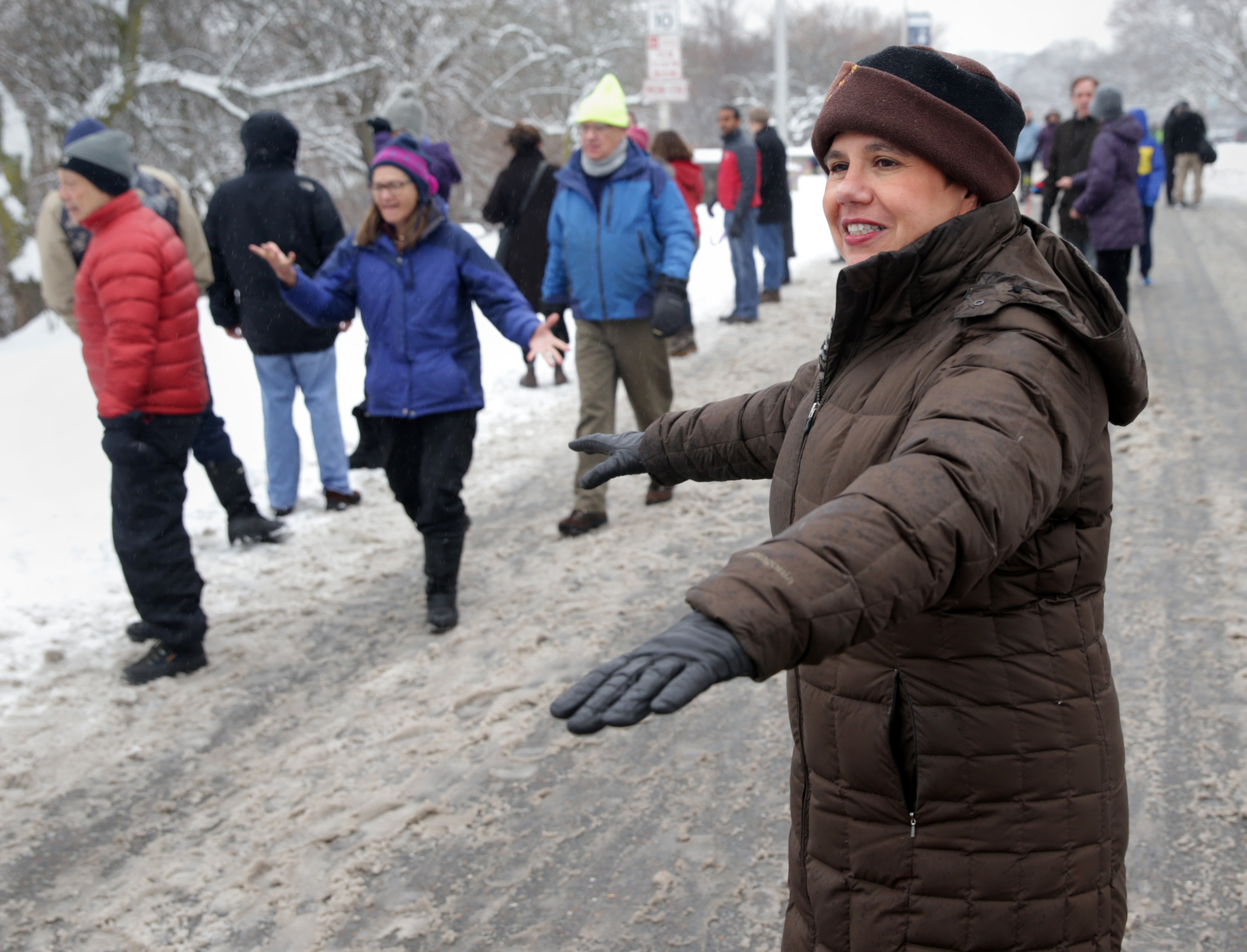 Donna Ruvolo organizes people at the "Hands Around the Pond "event in Belmont.
