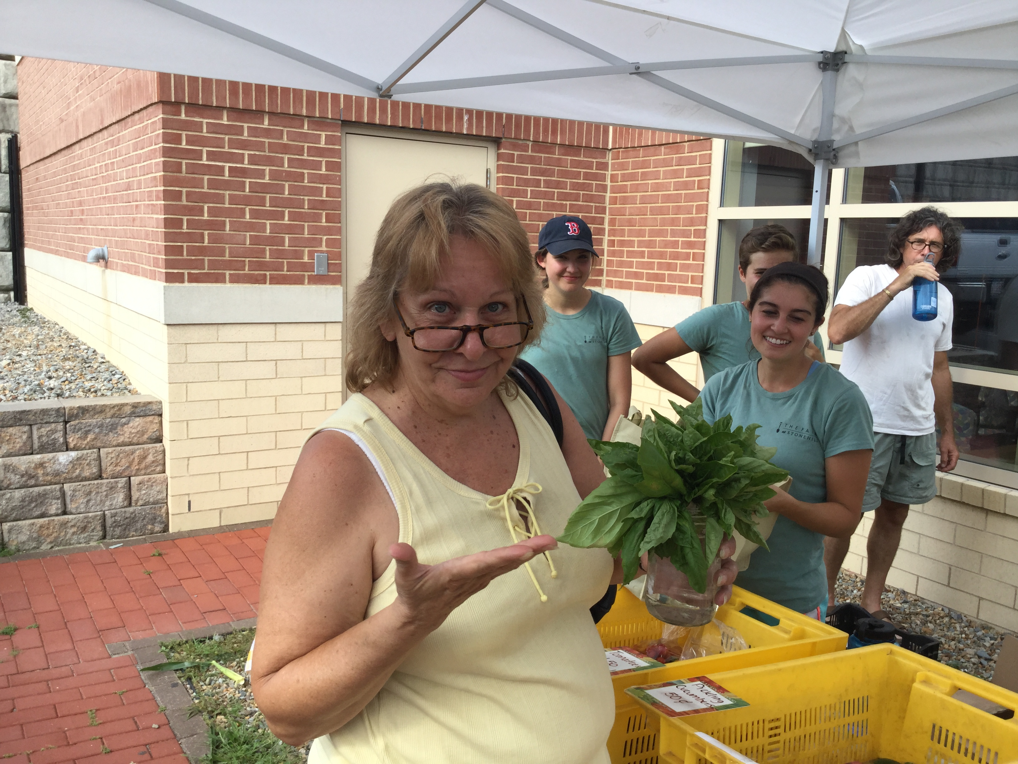 Brockton resident Cheryl Fink with her purchase from Stonehill College’s Mobile Market.