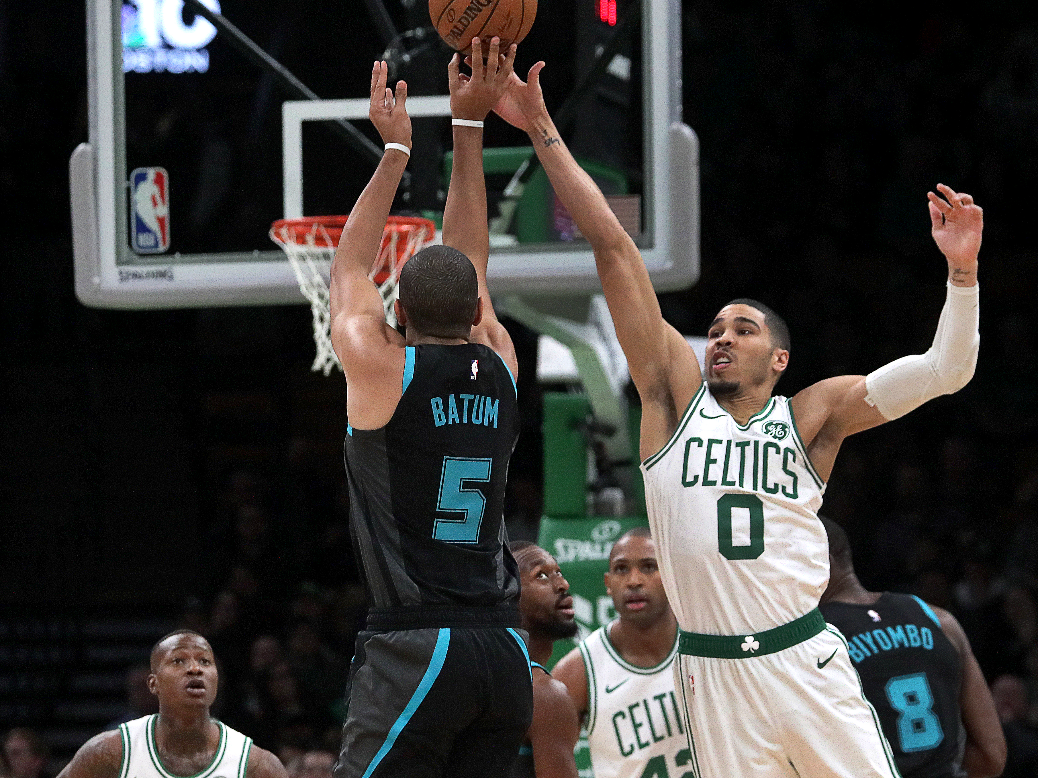Jayson Tatum tries to block a shot by the Hornets’ Nicolas Batum.