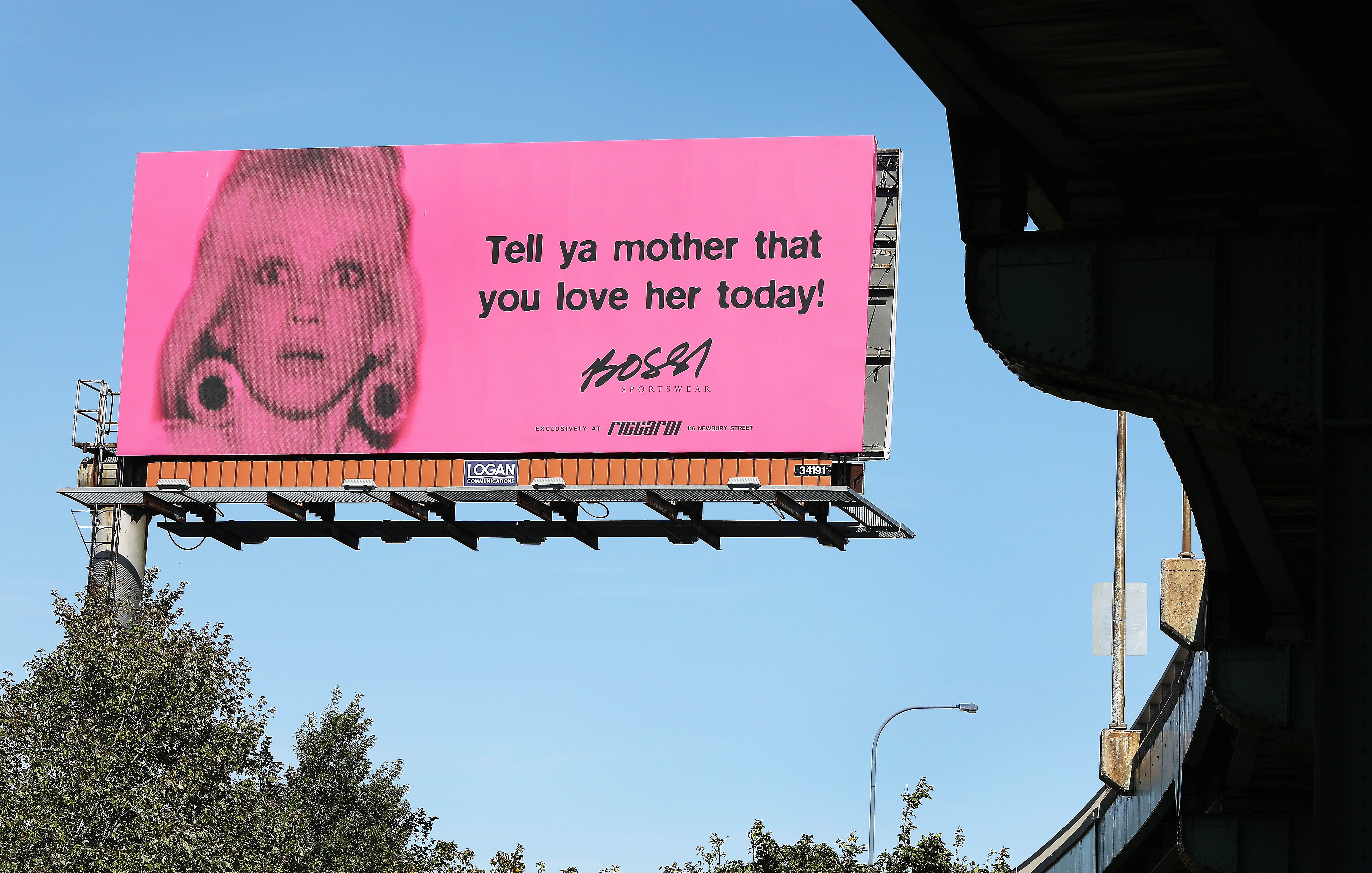If you’ve gone to Boston Logan Airport this summer, you may have seen Gail Bossi’s face gracing the pink Bossi billboard. It reads, “Tell ya mother that you love her today!”
