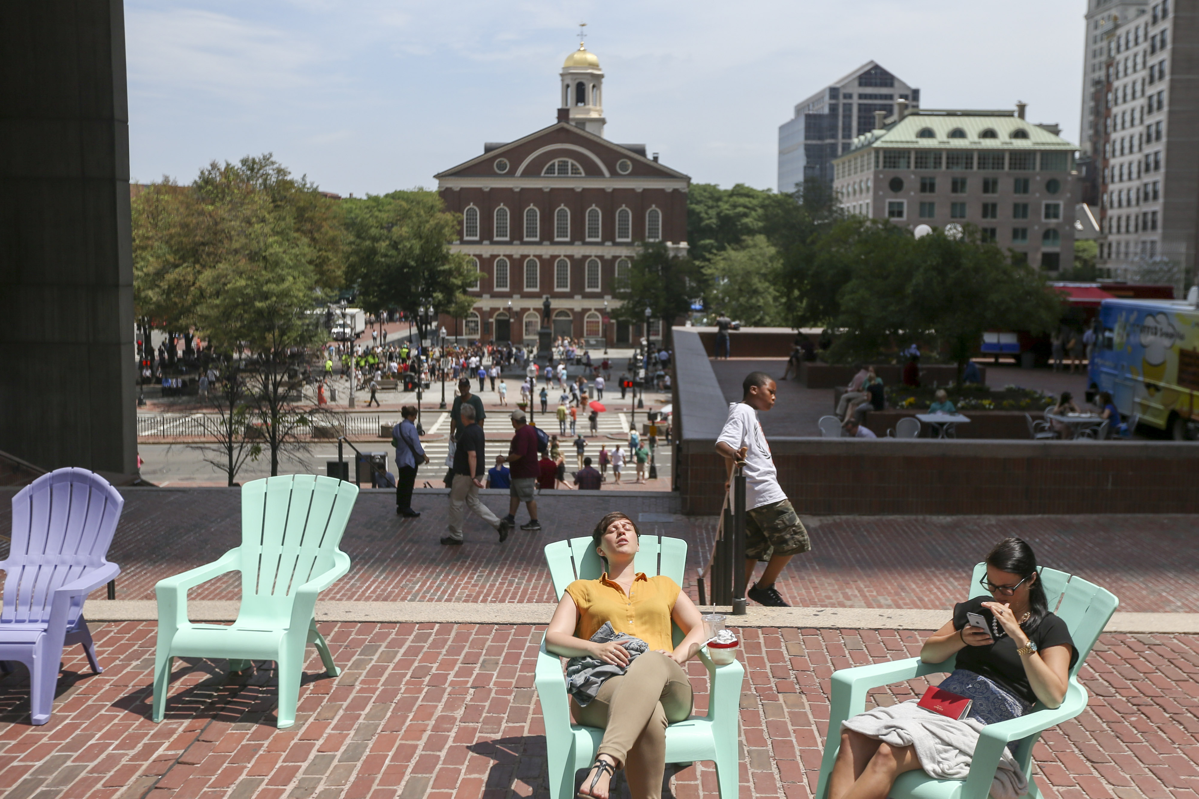 Visitors relax in lawn chairs on City Hall Plaza, part of an effort to make the public space more appealing.