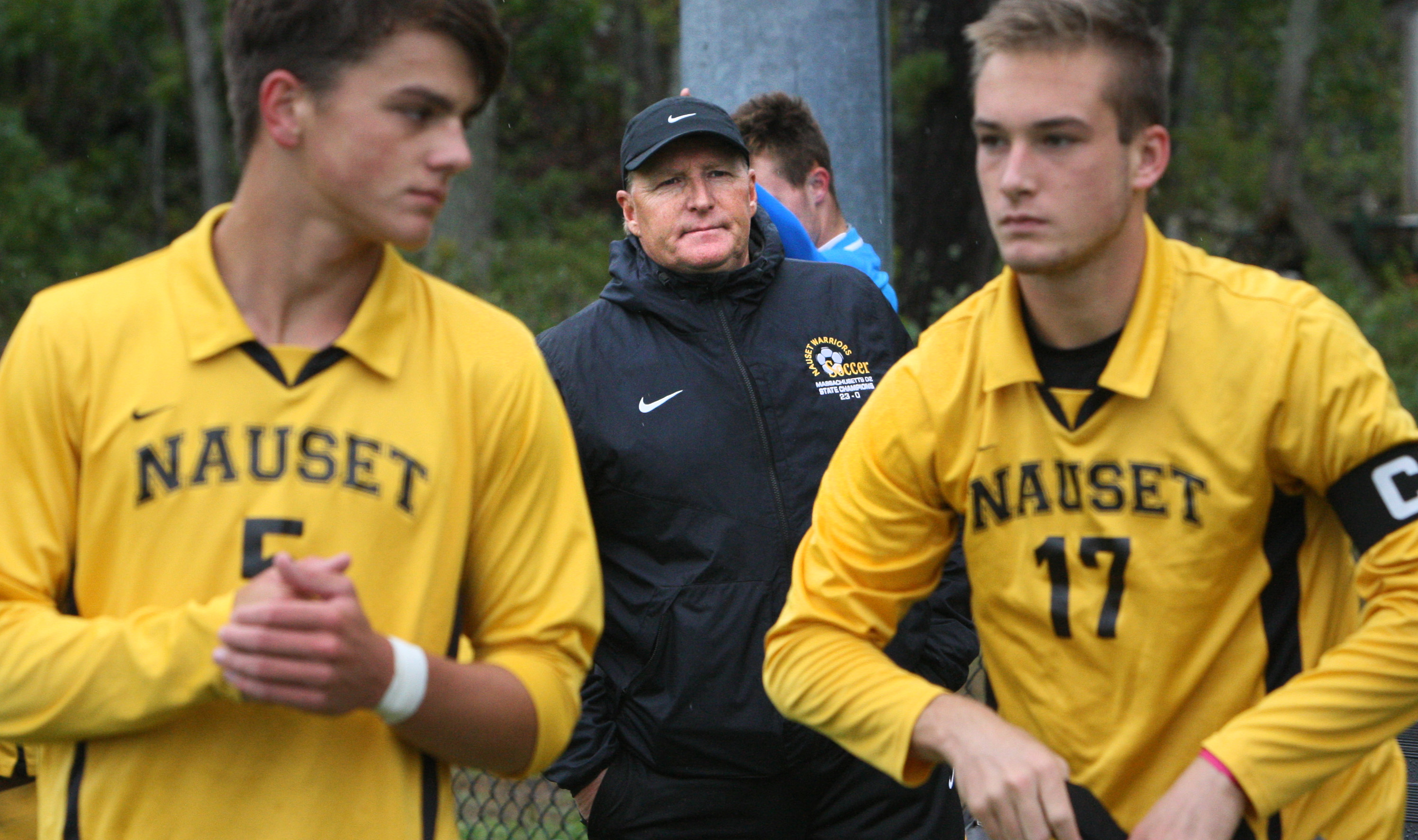 Nauset boys’ varsity soccer coach John McCully (center), supervising his players Sebastian Headrick (5) and Avery Santoro (17), has taught his team a tried-and-true approach to success: hard work, organization, and a professional demeanor.