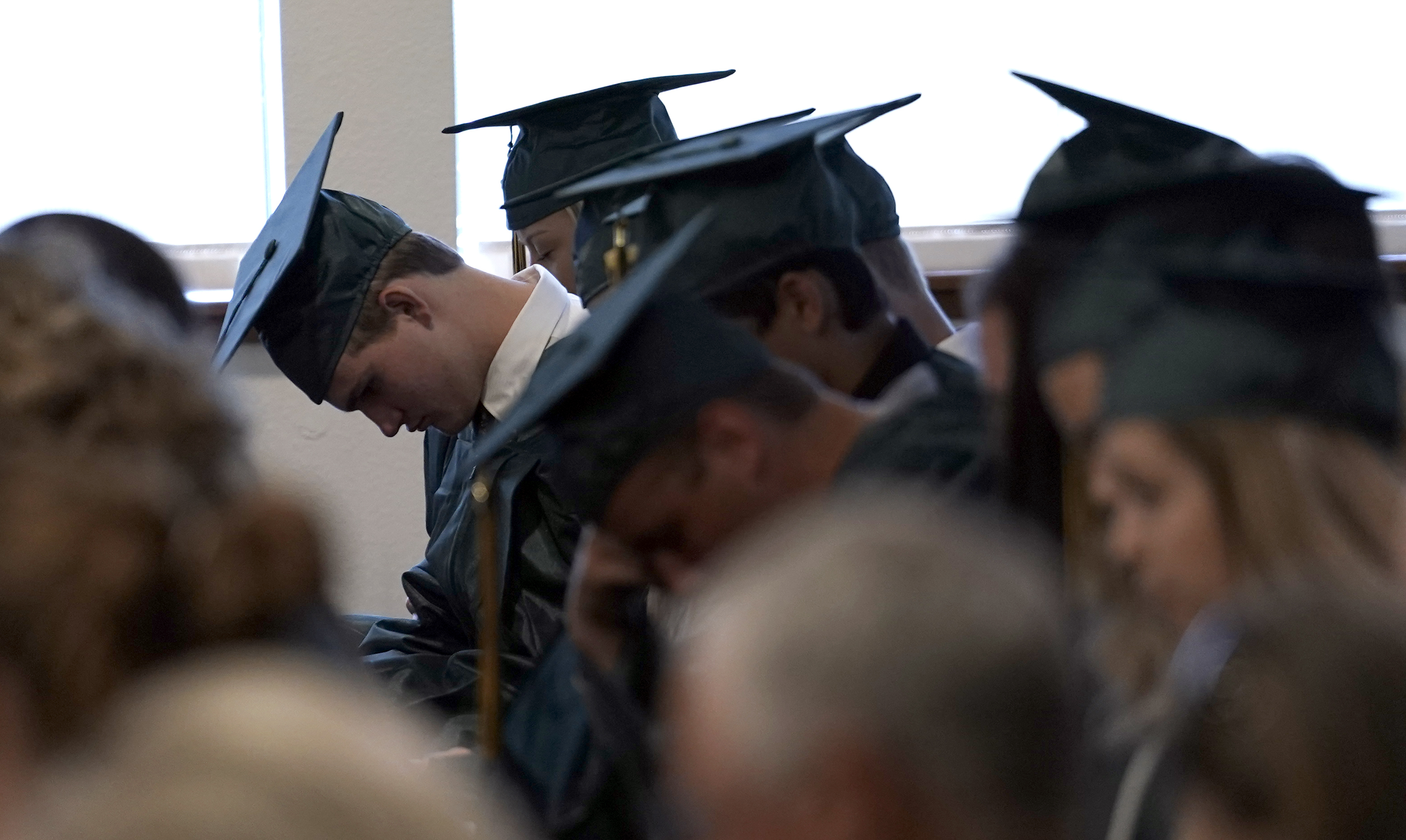 Santa Fe High School graduates bowed their heads in prayer during a baccalaureate service on Sunday.