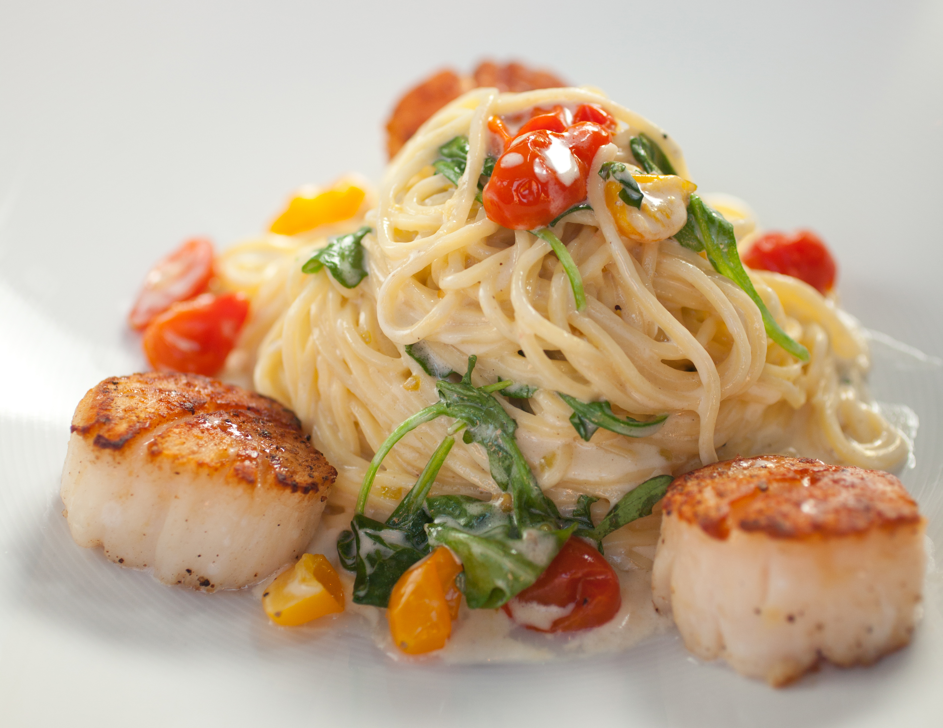 The lemon angel hair pasta served with pan seared diver scallops.