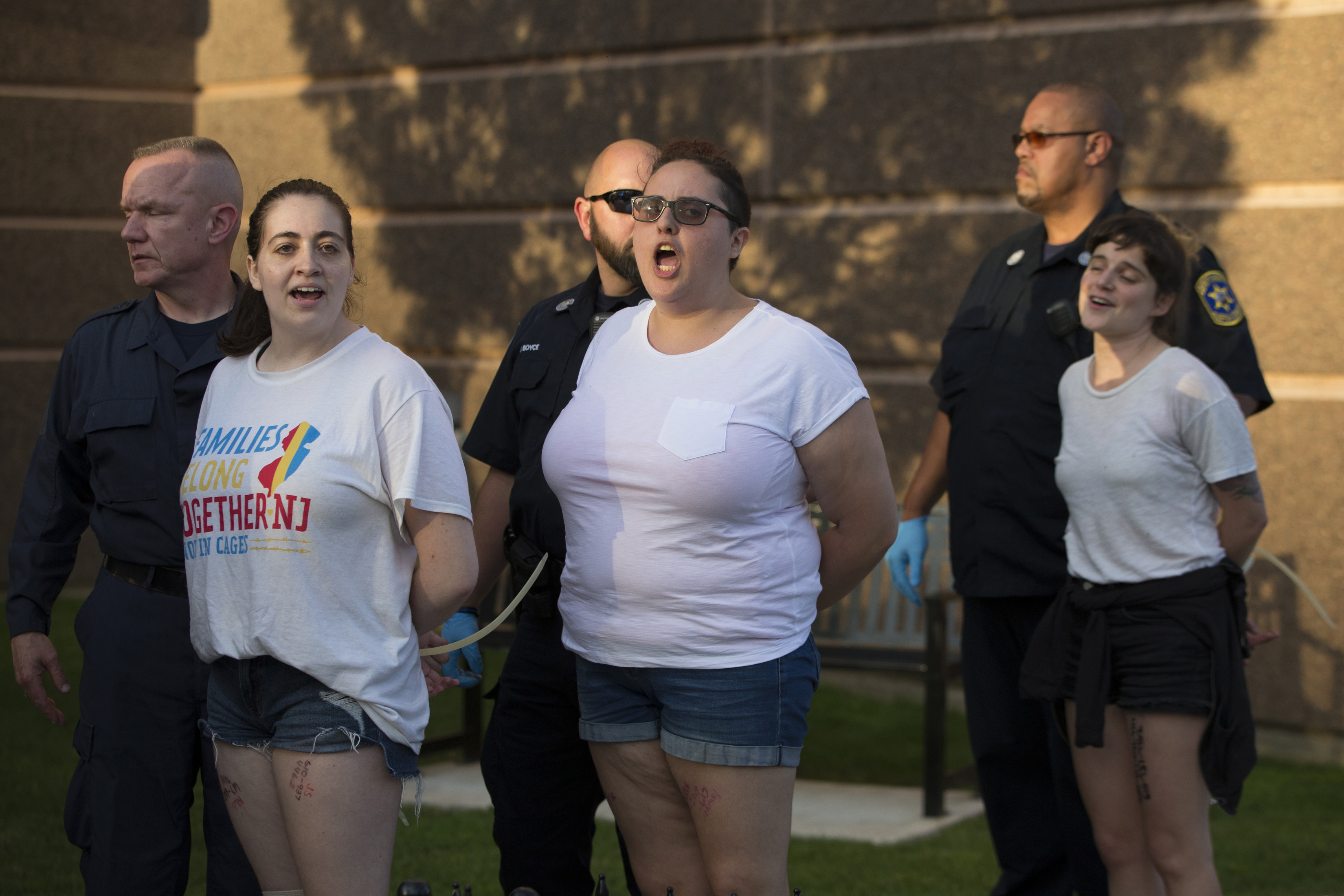 Protesters arrested during the march and rally outside the Suffolk County Sheriff’s Department in Boston on Tuesday.