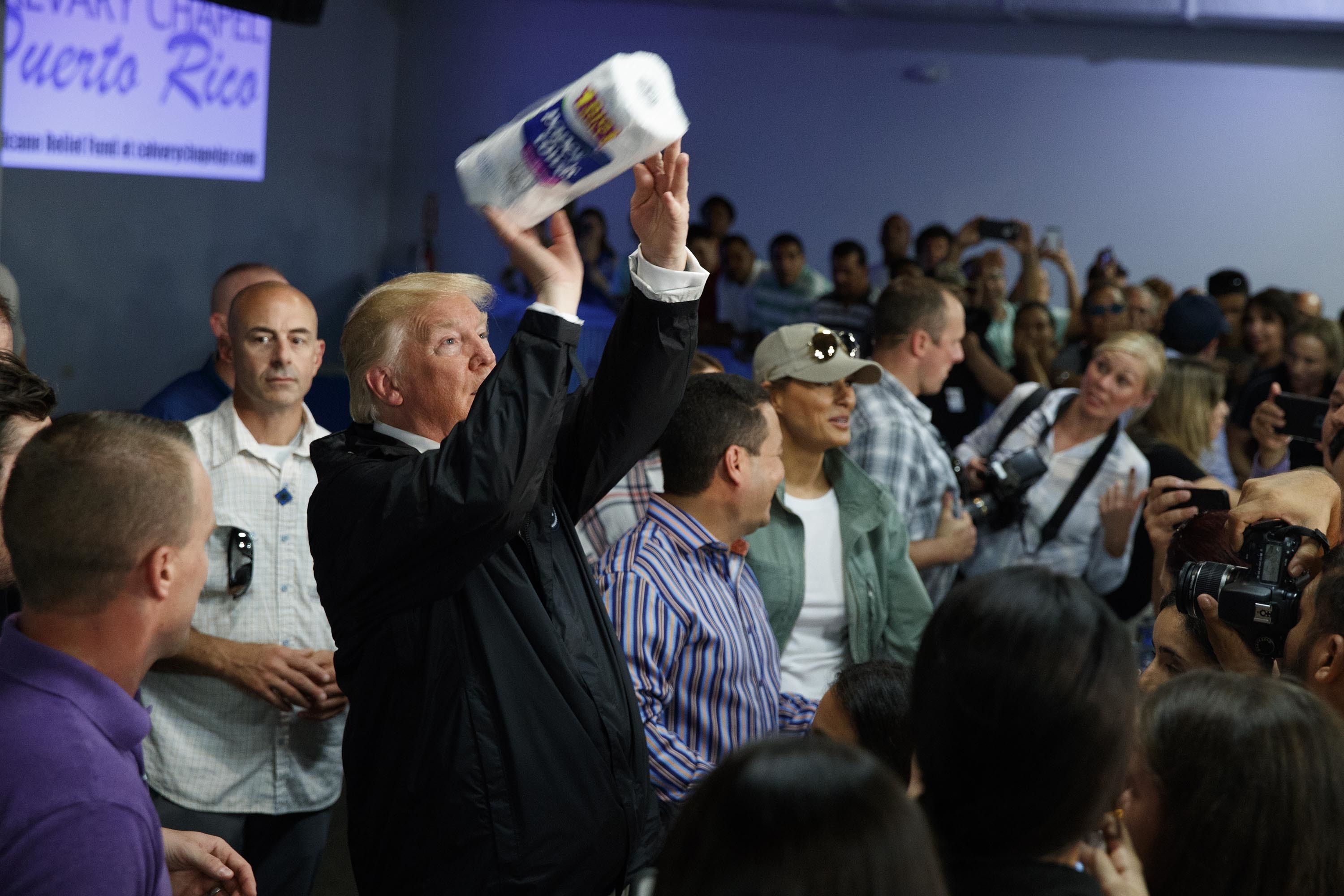President Donald Trump tossed paper towels into a crowd as he hands out supplies at Calvary Chapel in Guaynabo, Puerto Rico.