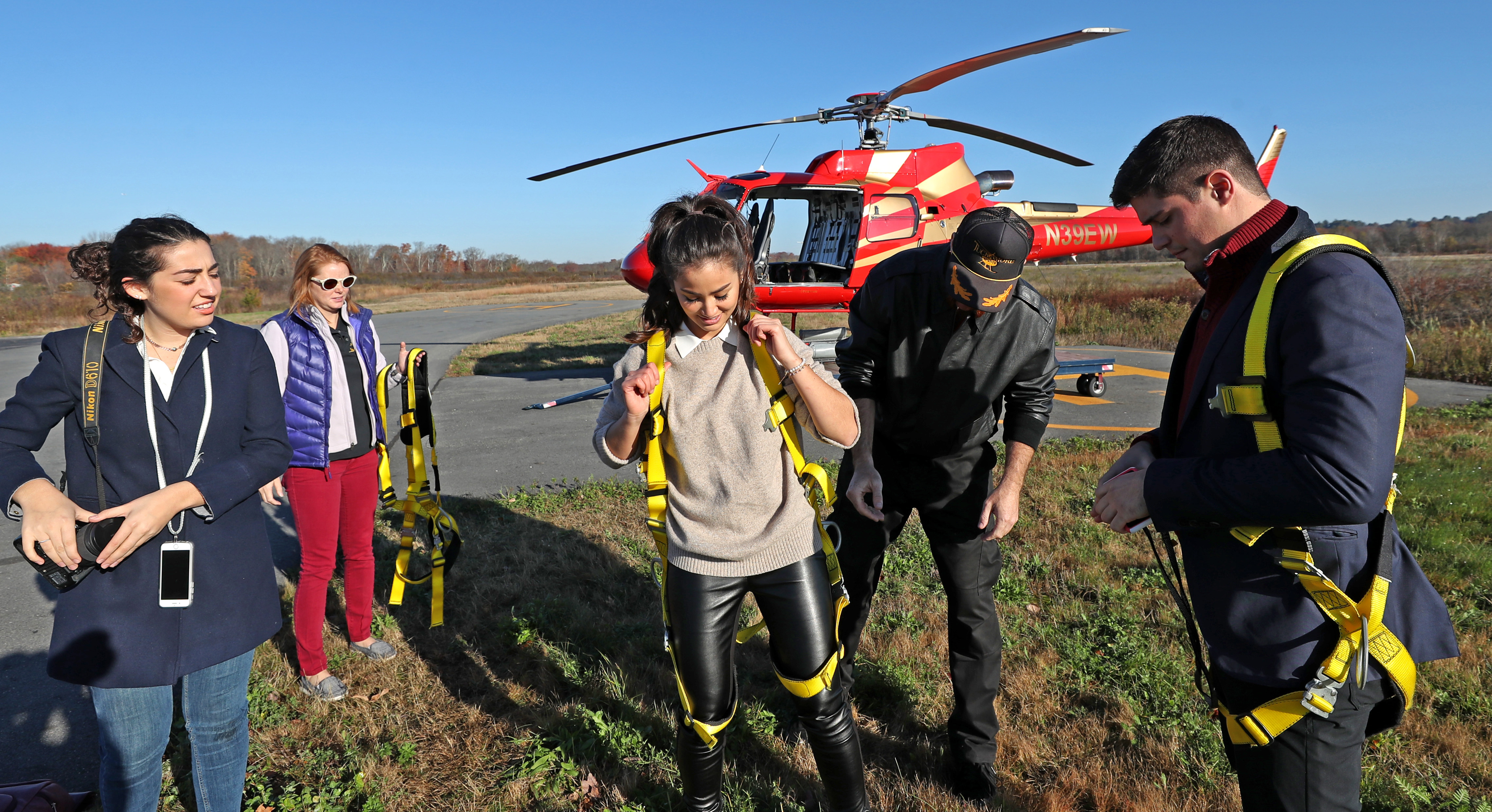 Pilot Jeff Hubbard helps prepare passengers for the Hover Boston flight at Norwood Airport.