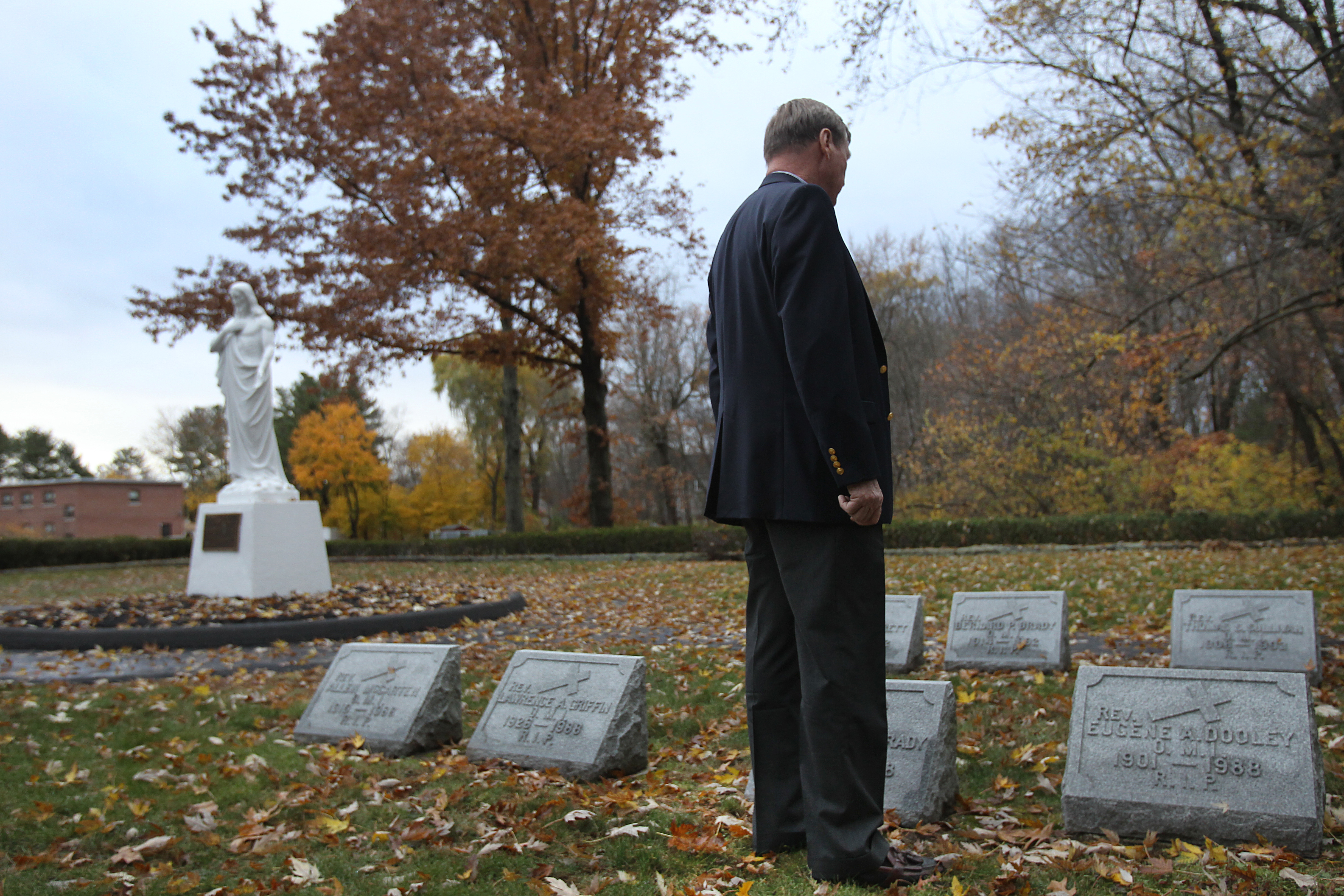 Jim Graham visited the grave of the man he believes was his father, the Rev. Thomas S. Sulllivan, in Tewksbury.