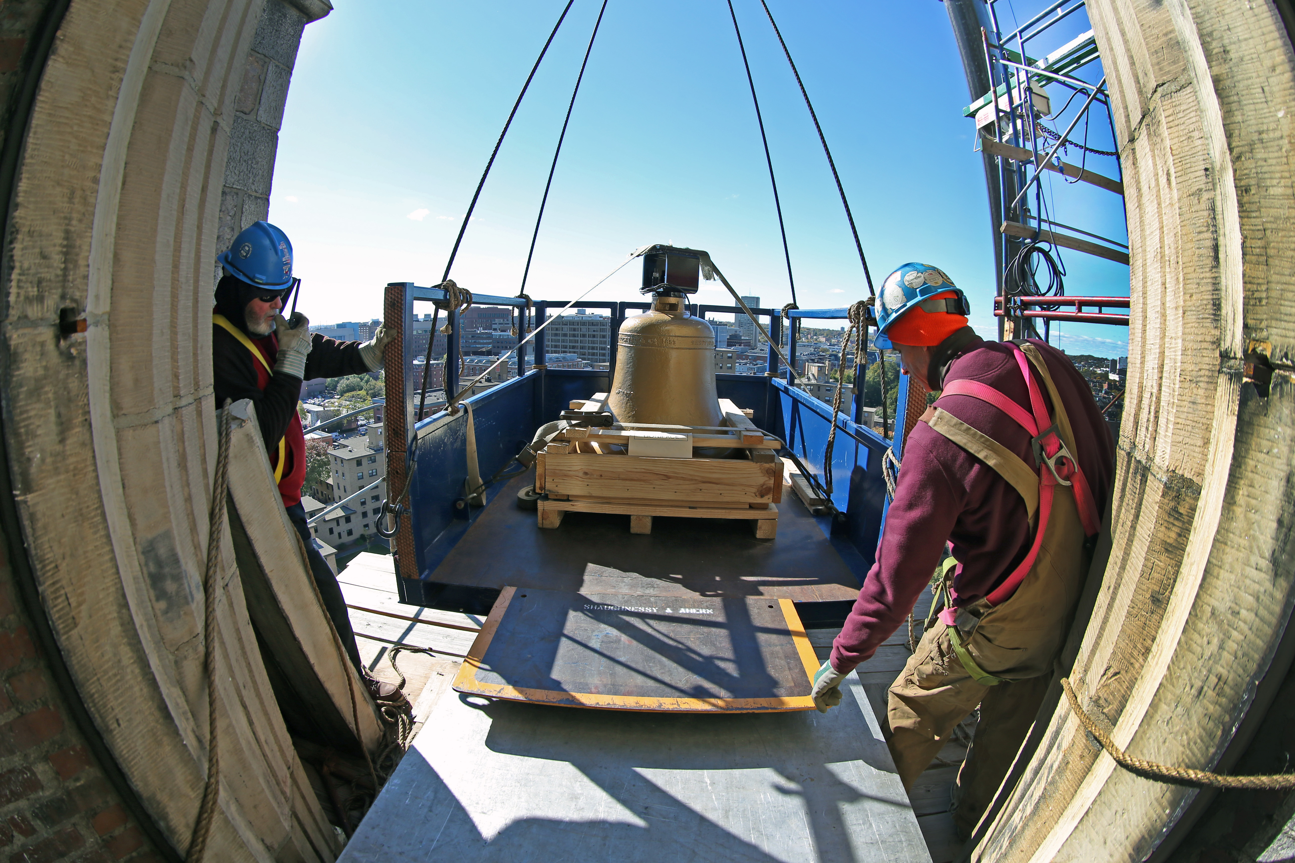 Wally Delaney and Glen Hanson pulled a bell into the church tower.