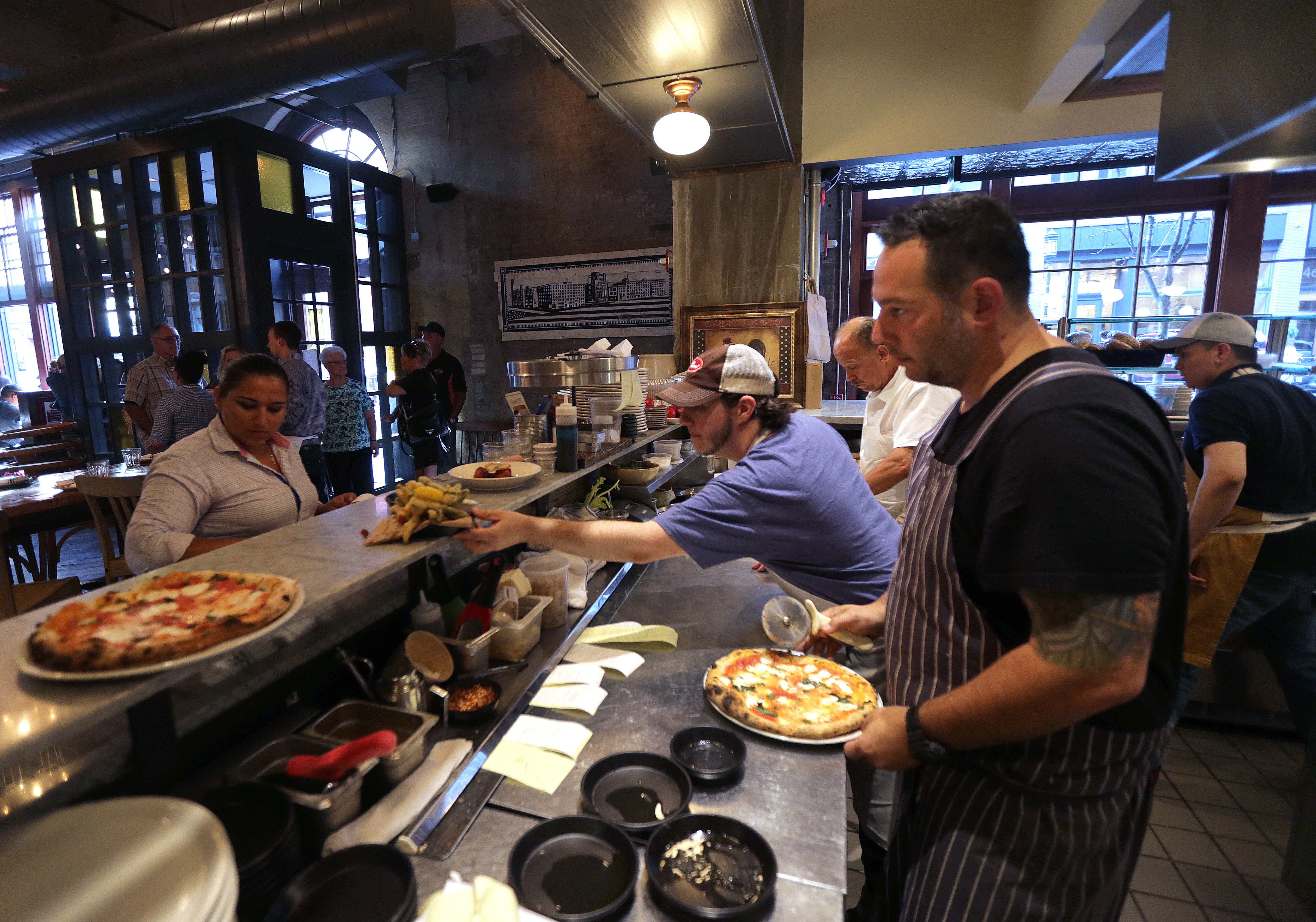 Todd Winer (right), owner of Pastoral in the Fort Point neighborhood, has helped some employees find affordable housing, a persistent problem in a city with fast-rising rents.