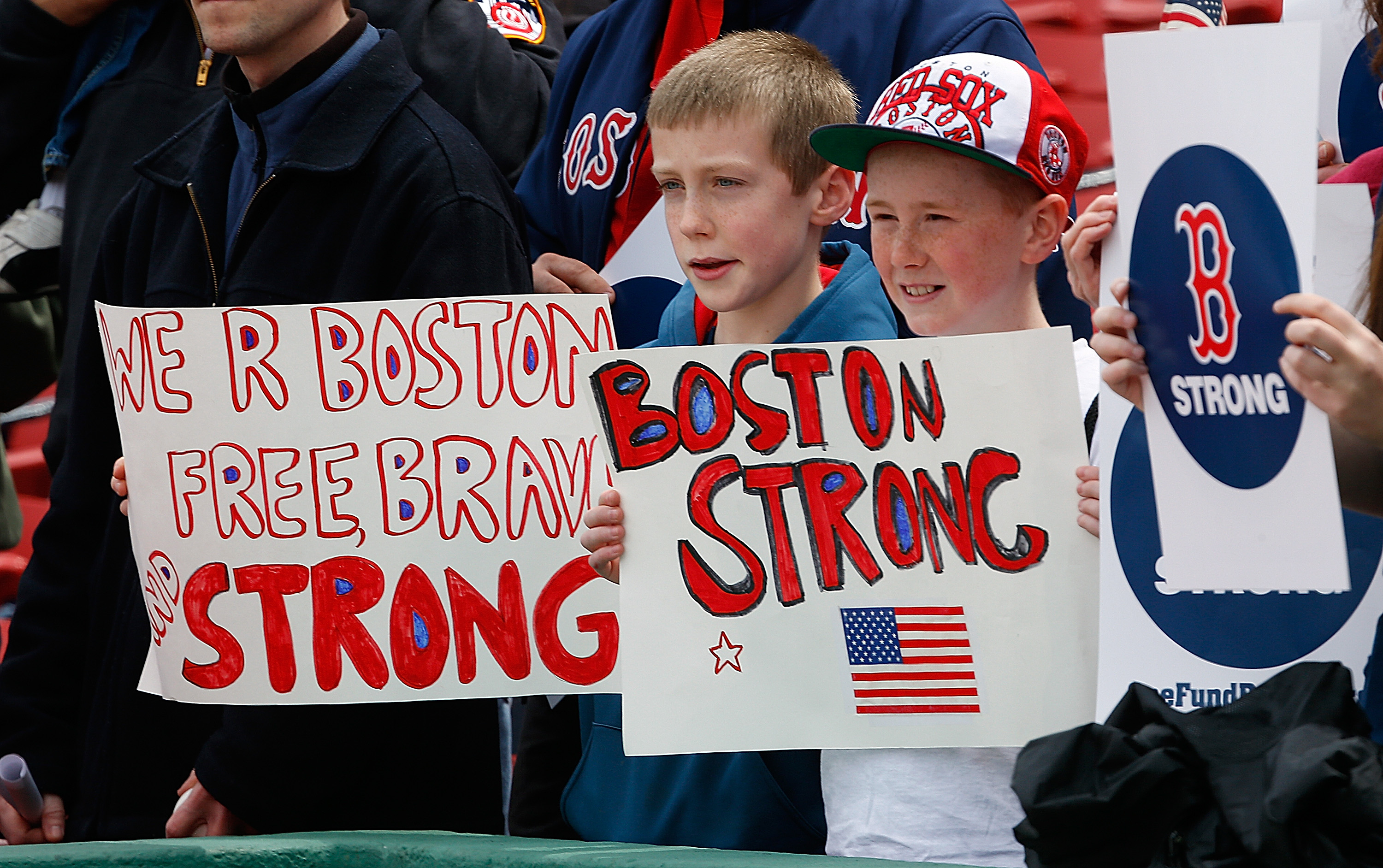 Fans held signs at Fenway park on Saturday.