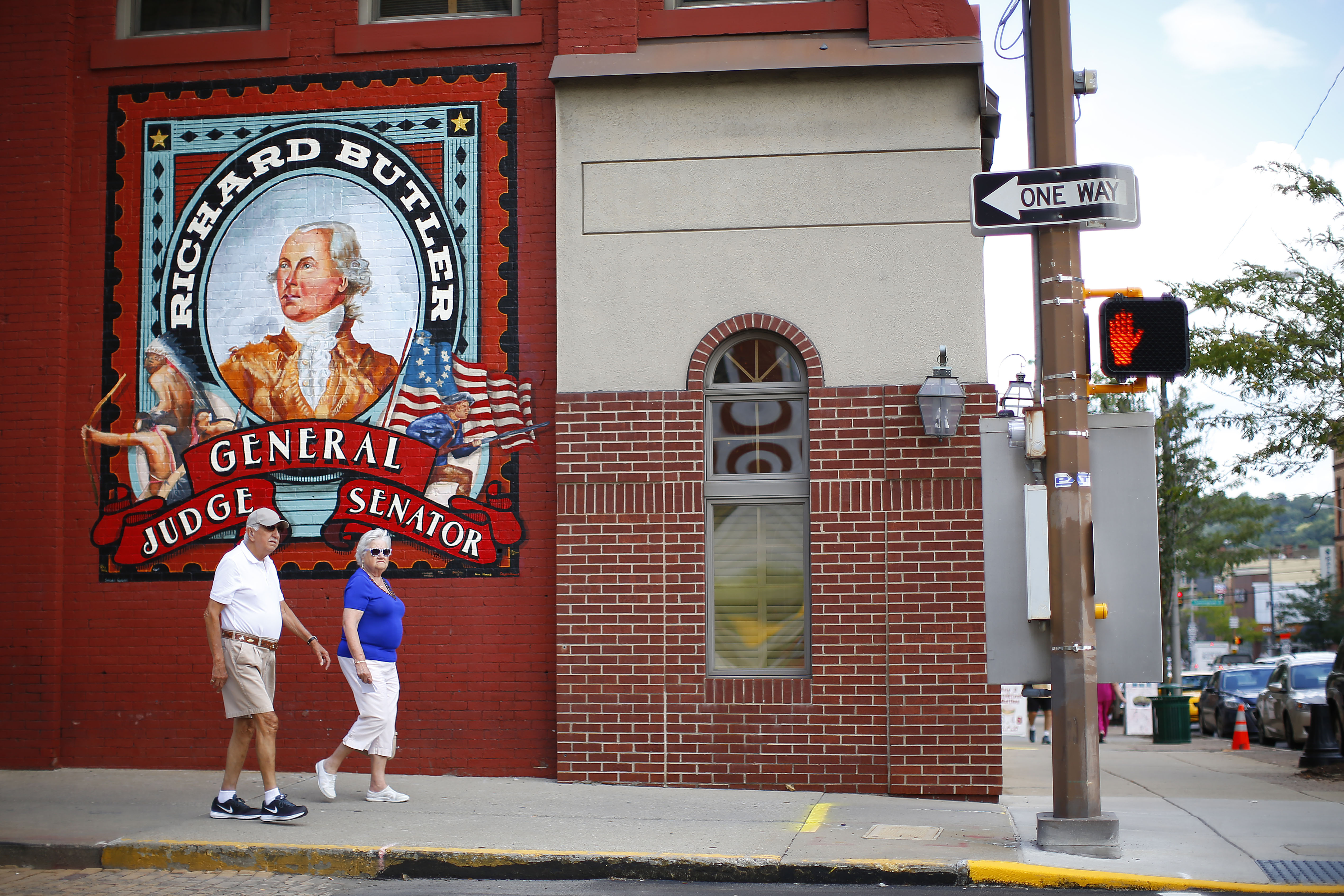 A couple walked past a newly commissioned mural in downtown Butler.