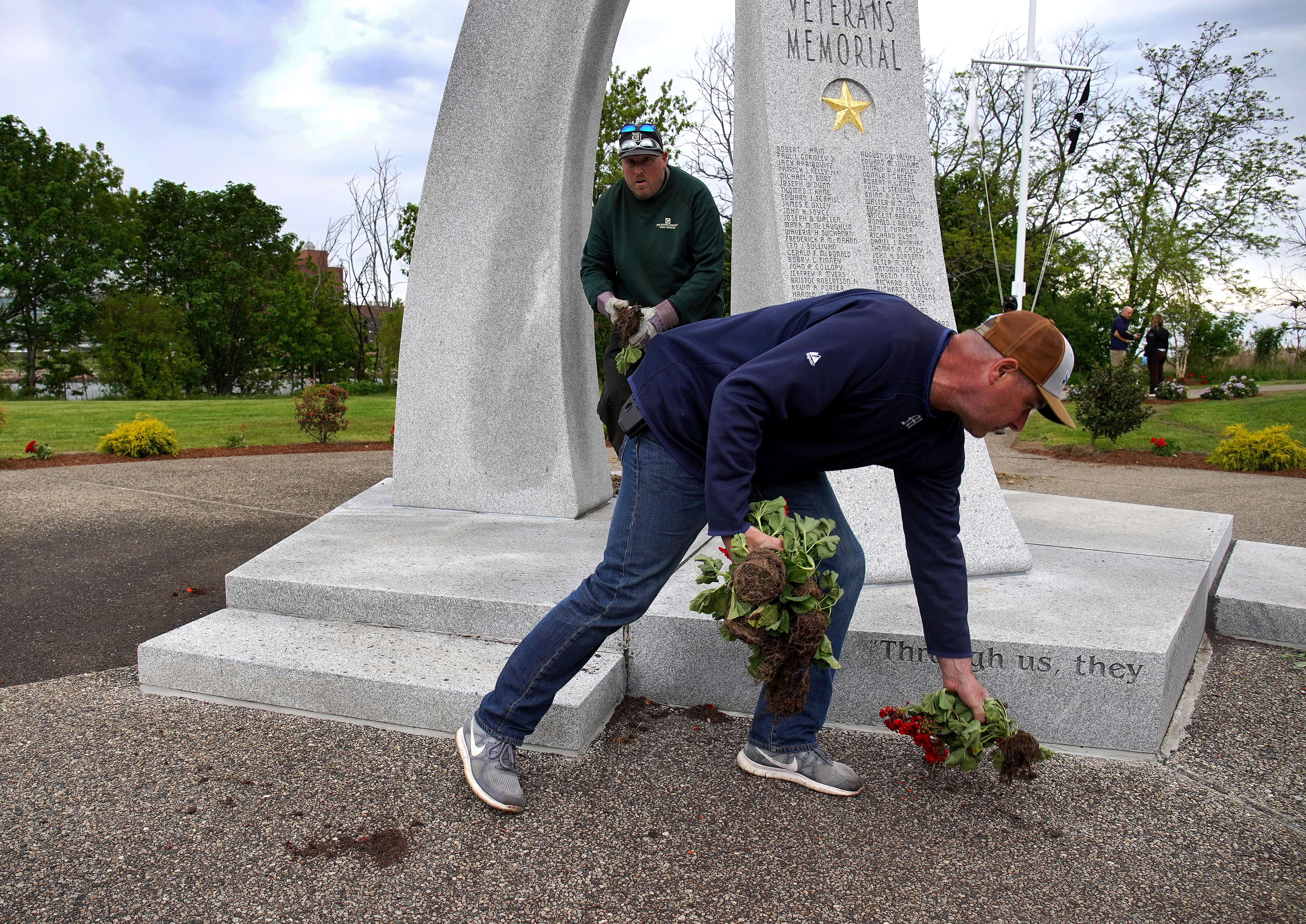 Workers collected the flowers that had been pulled out of the ground.